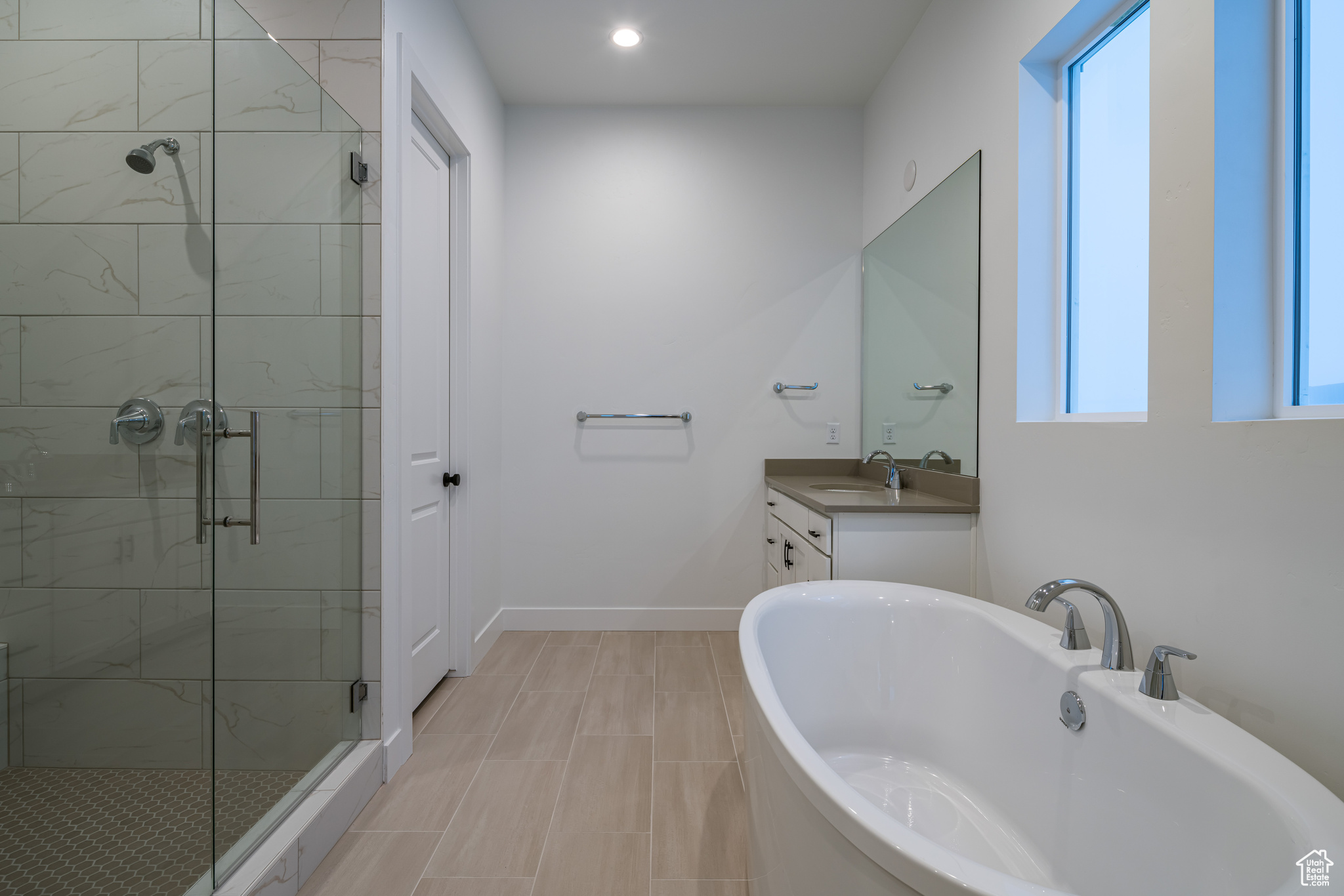 Bathroom with vanity, tile floors, and separate shower and tub