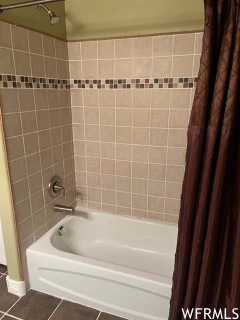 Bathroom with shower / bath combination with curtain and tile floors