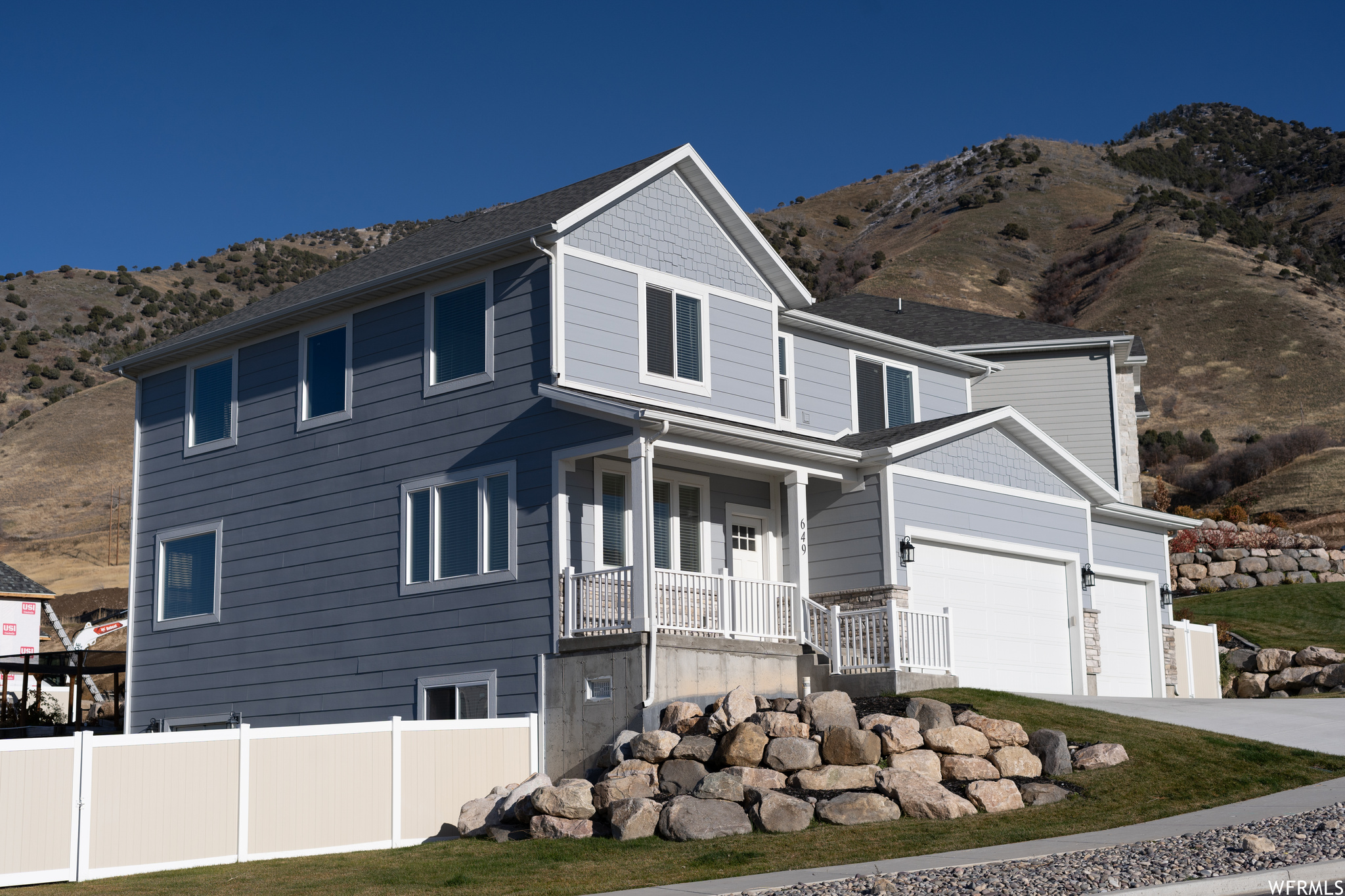 View of front facade with a garage and a mountain view