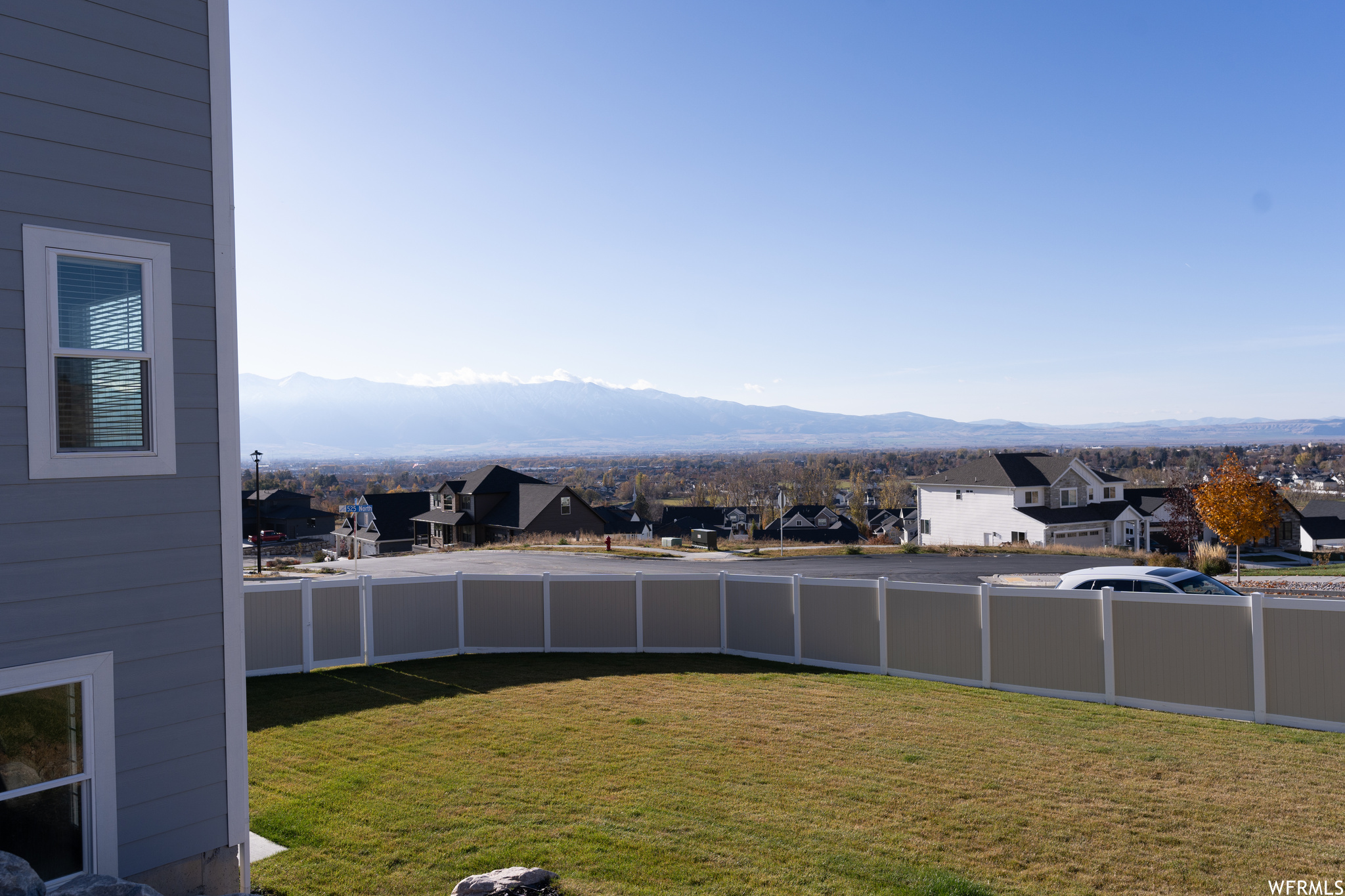 View of fully fenced yard featuring a mountain view