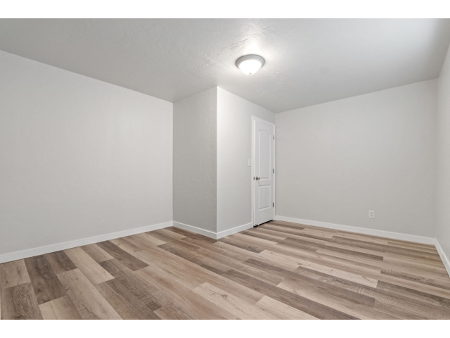 Basement bedroom featuring light hardwood / wood-style floors