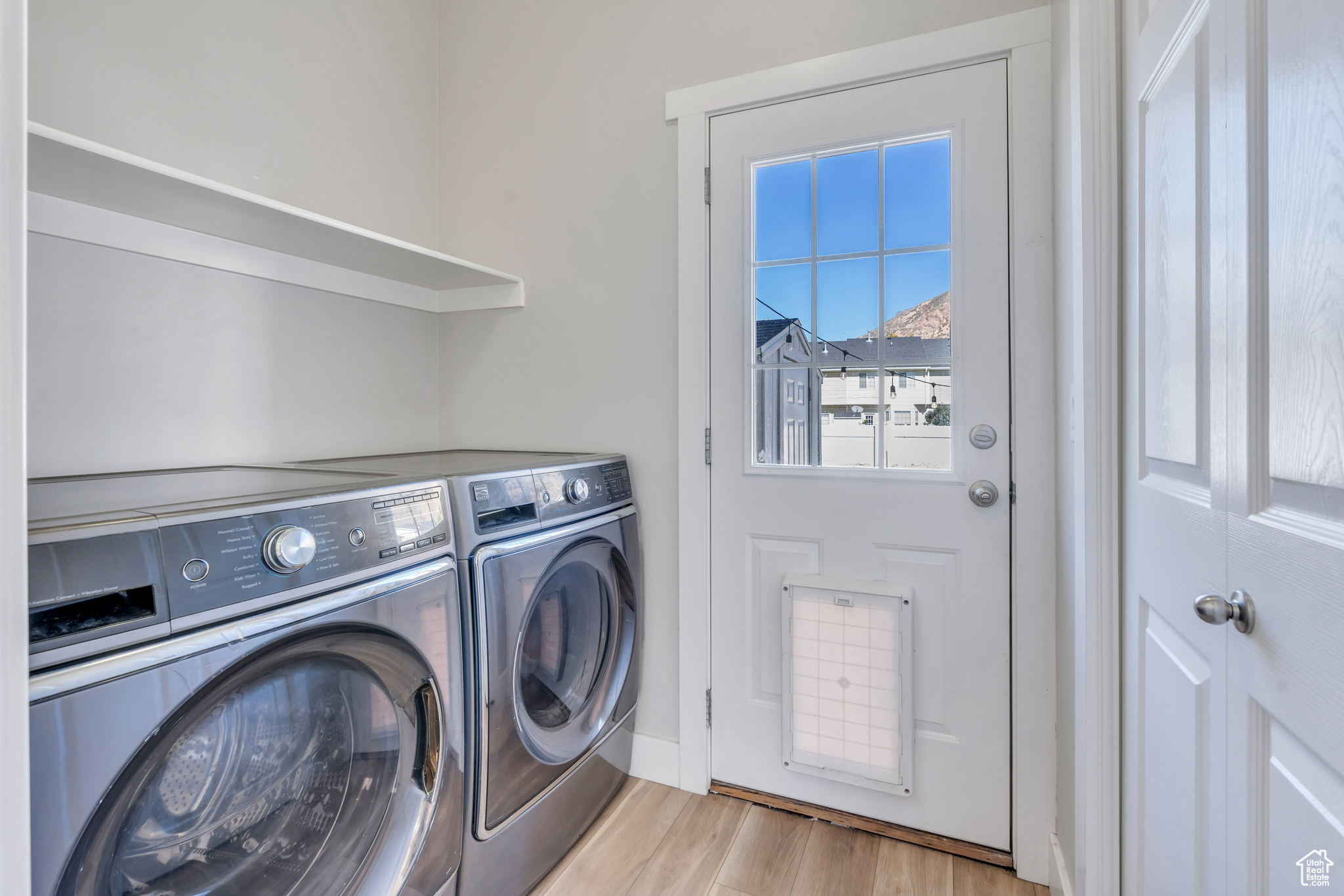 Washroom featuring washer and dryer and light hardwood / wood-style flooring