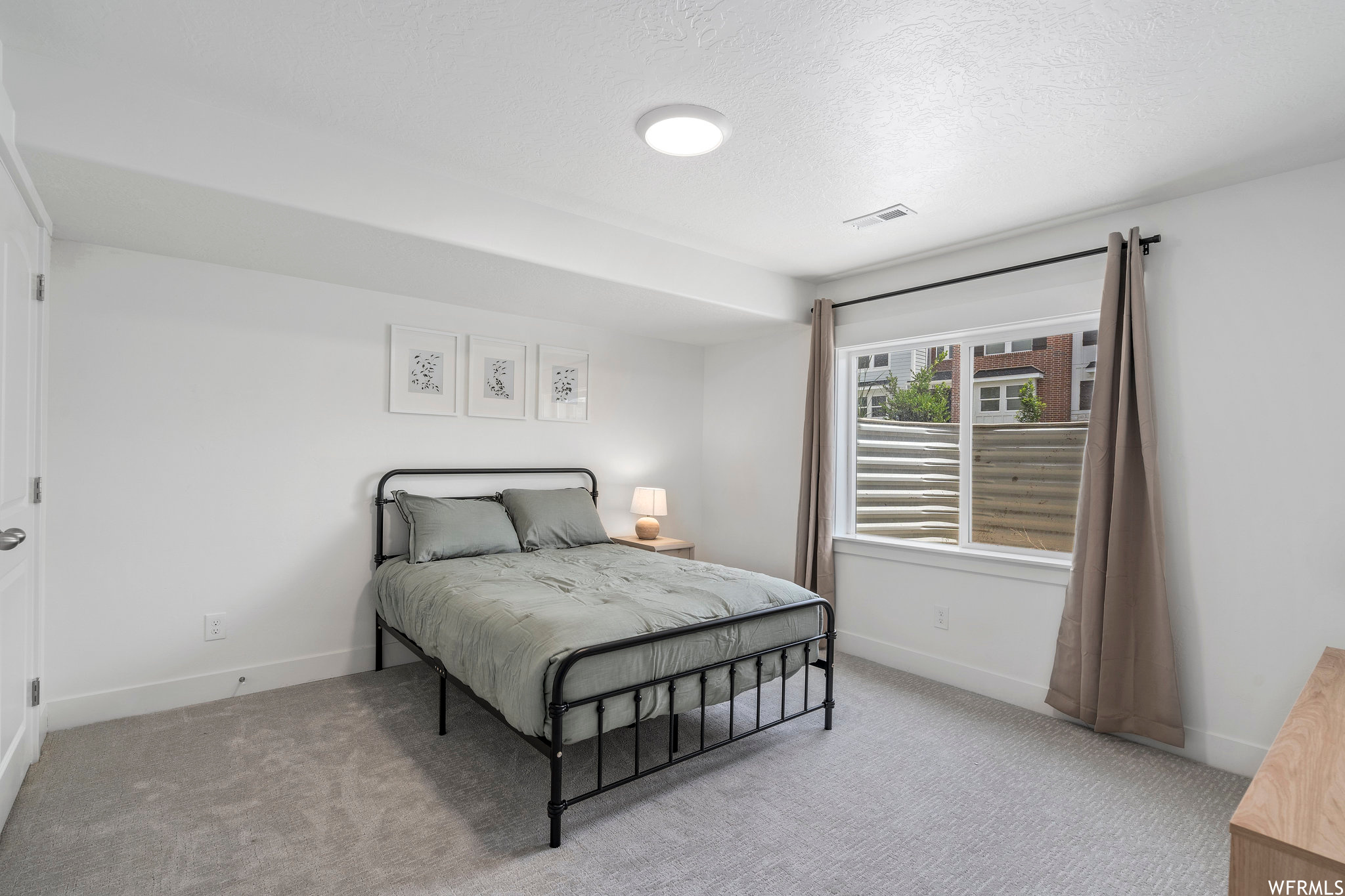 Carpeted bedroom featuring a textured ceiling