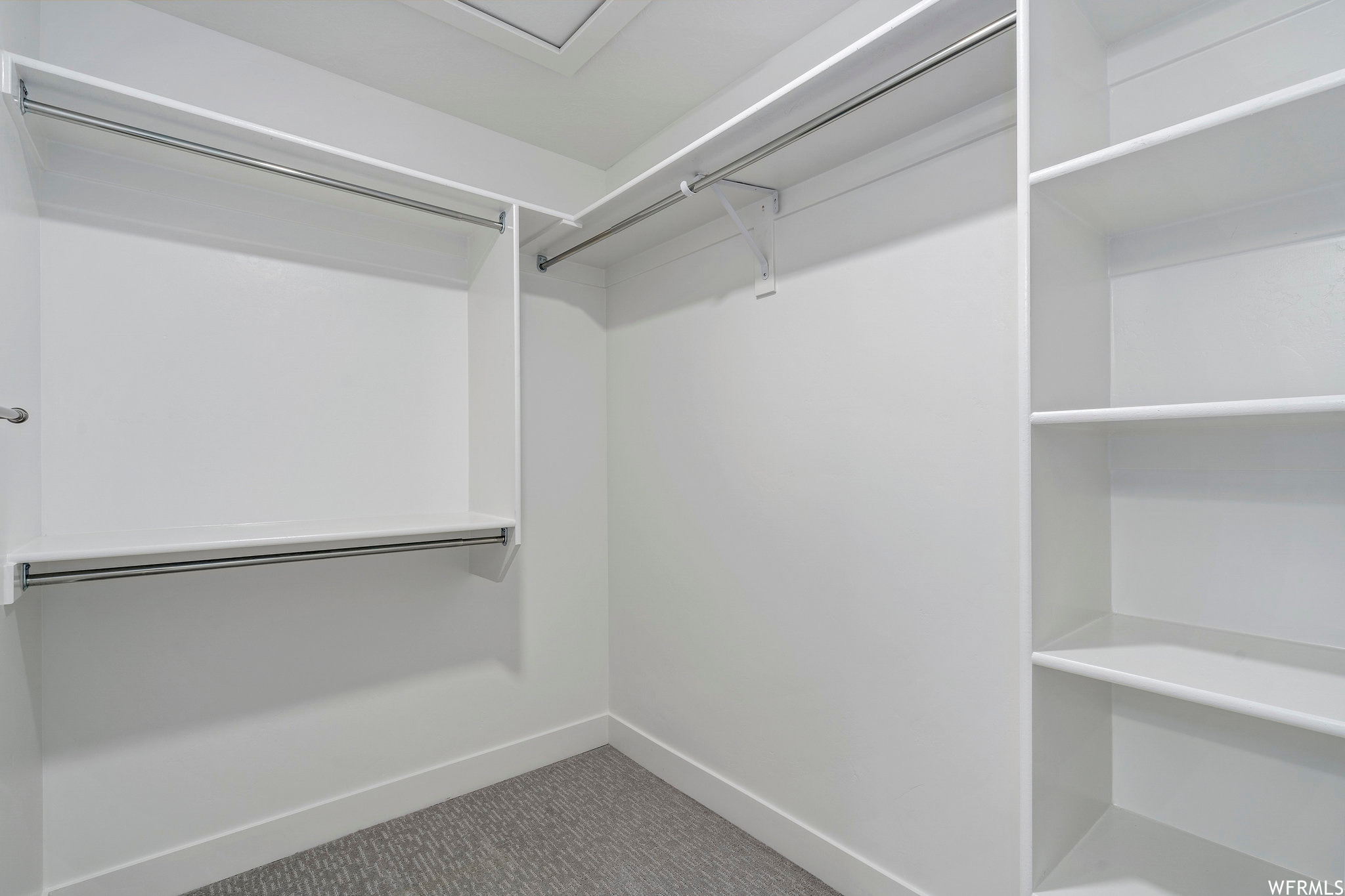 Spacious closet with carpet