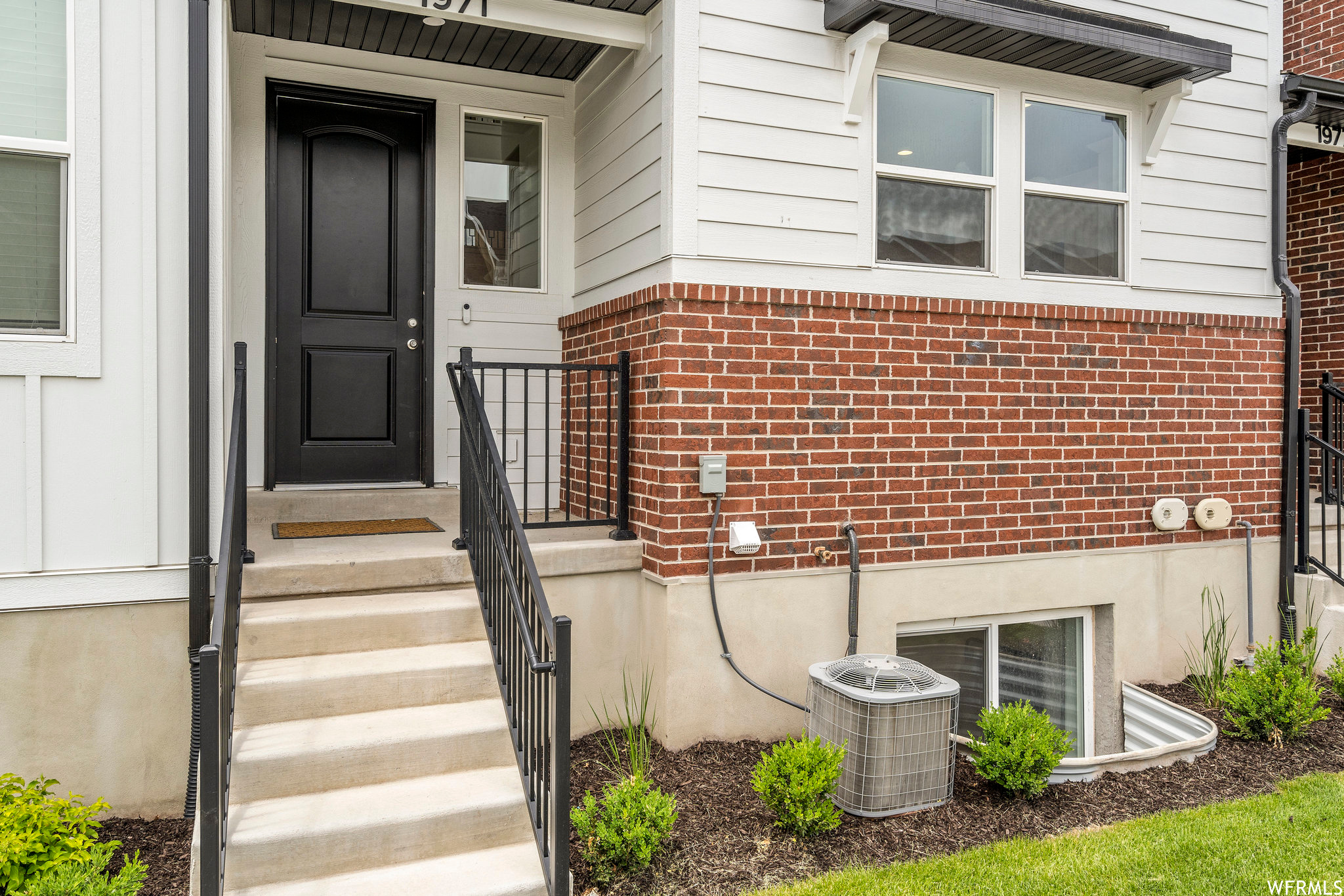 Entrance to property featuring central AC