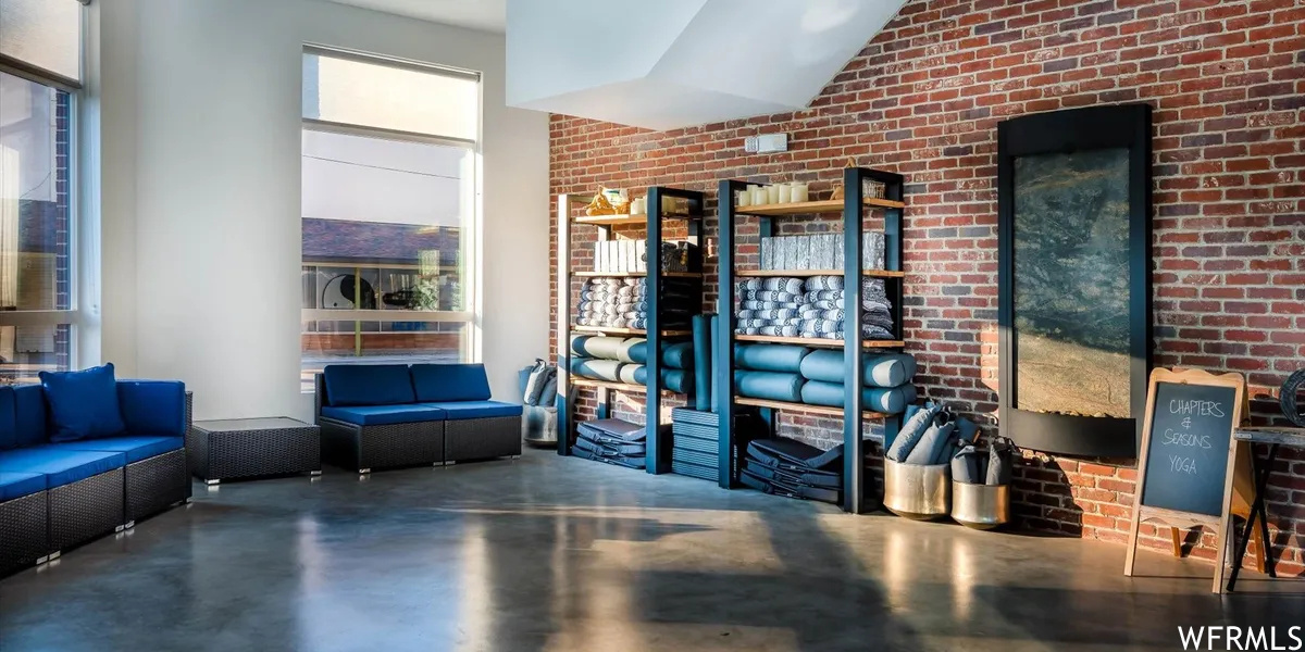 Interior space with a high ceiling and brick wall