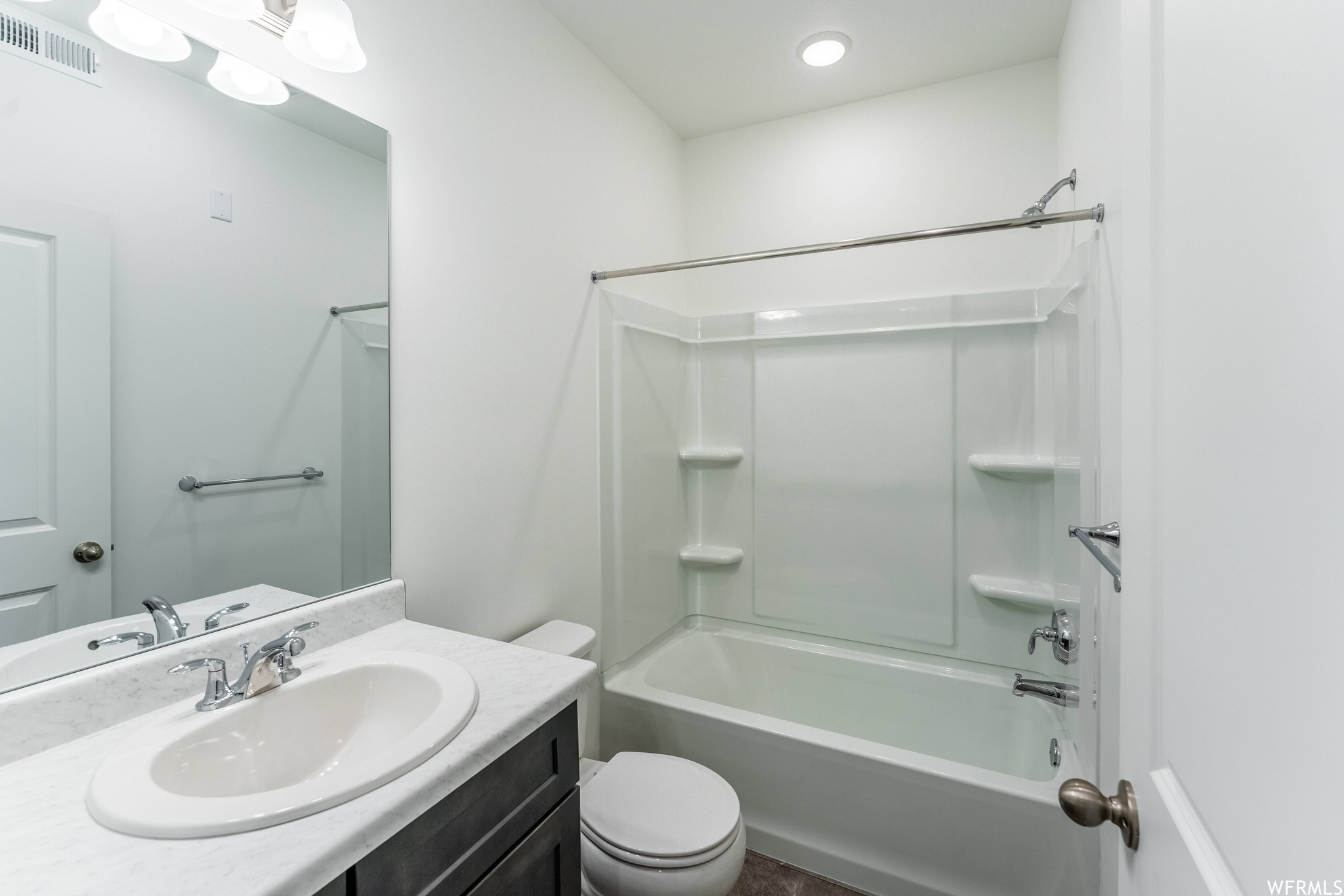 Full bathroom with toilet, vanity with extensive cabinet space, and  shower combination