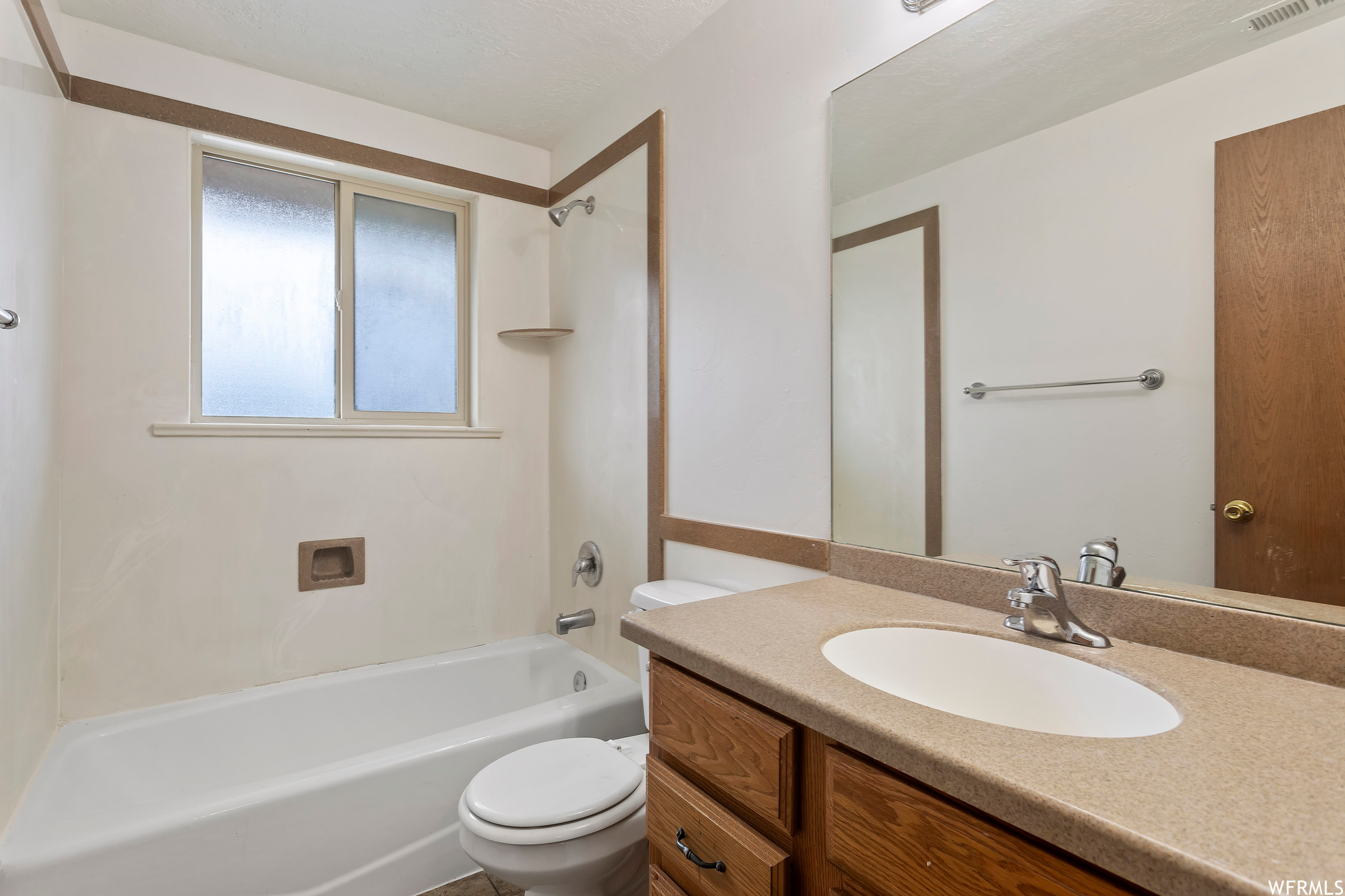 Full bathroom featuring tub / shower combination, oversized vanity, and toilet