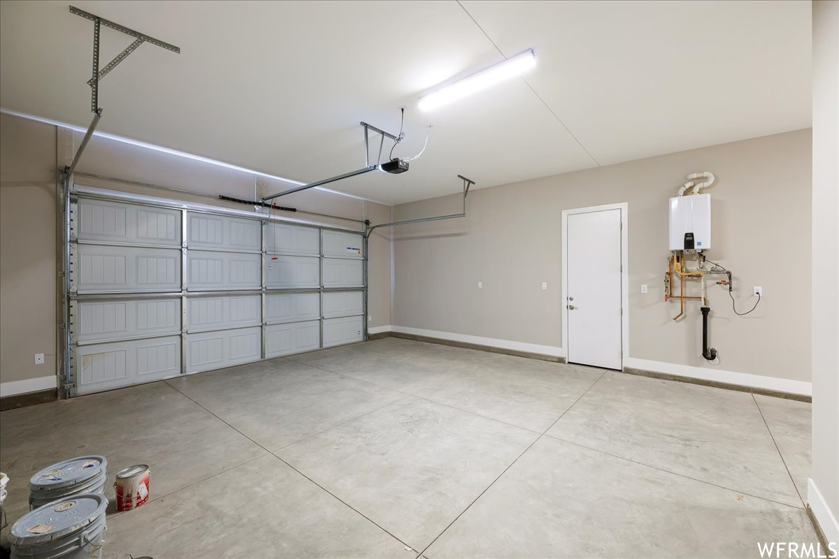 Garage with water heater and a garage door opener