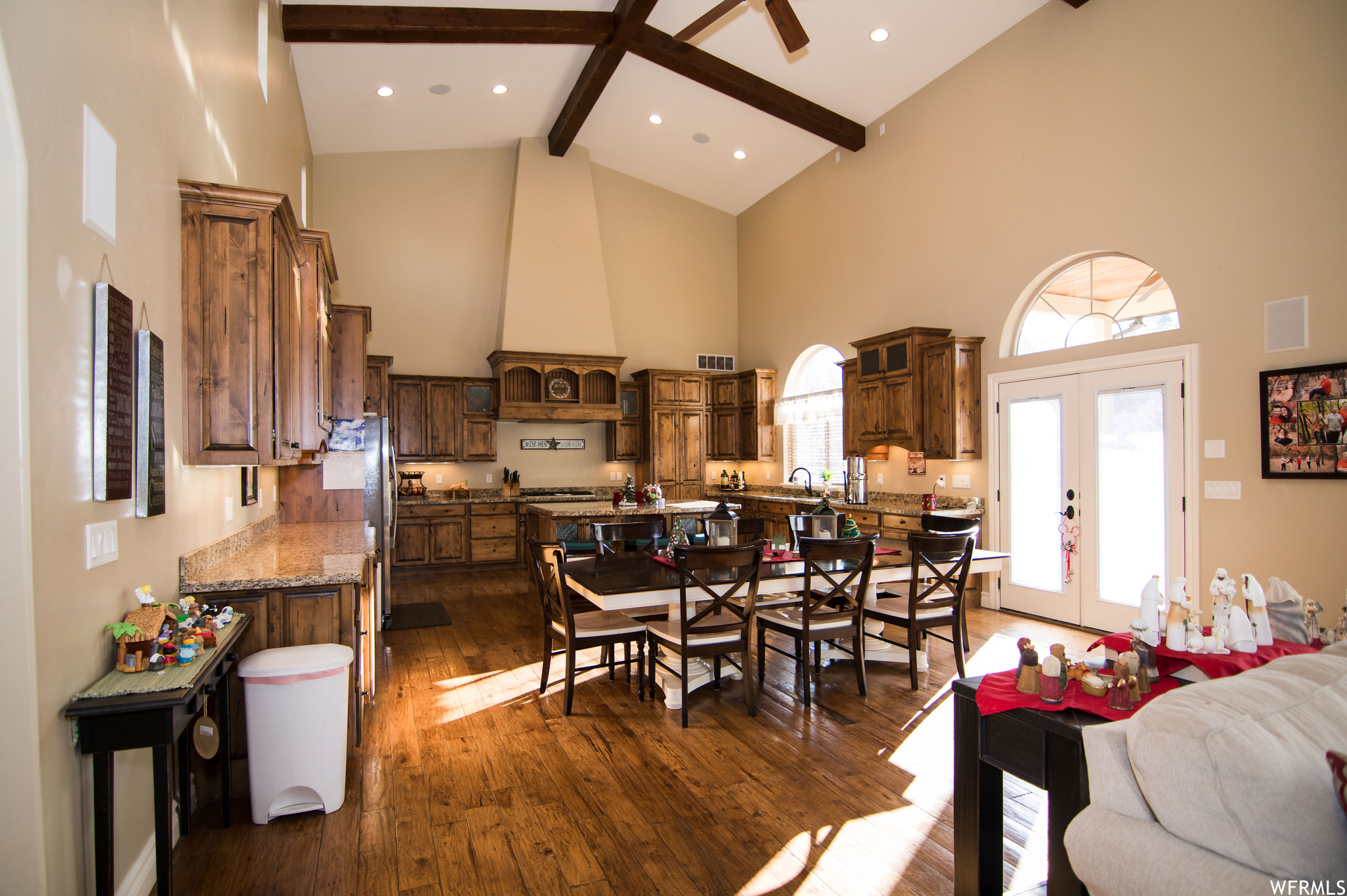 Dining space with sink, high vaulted ceiling, french doors, dark wood-type flooring, and beamed ceiling