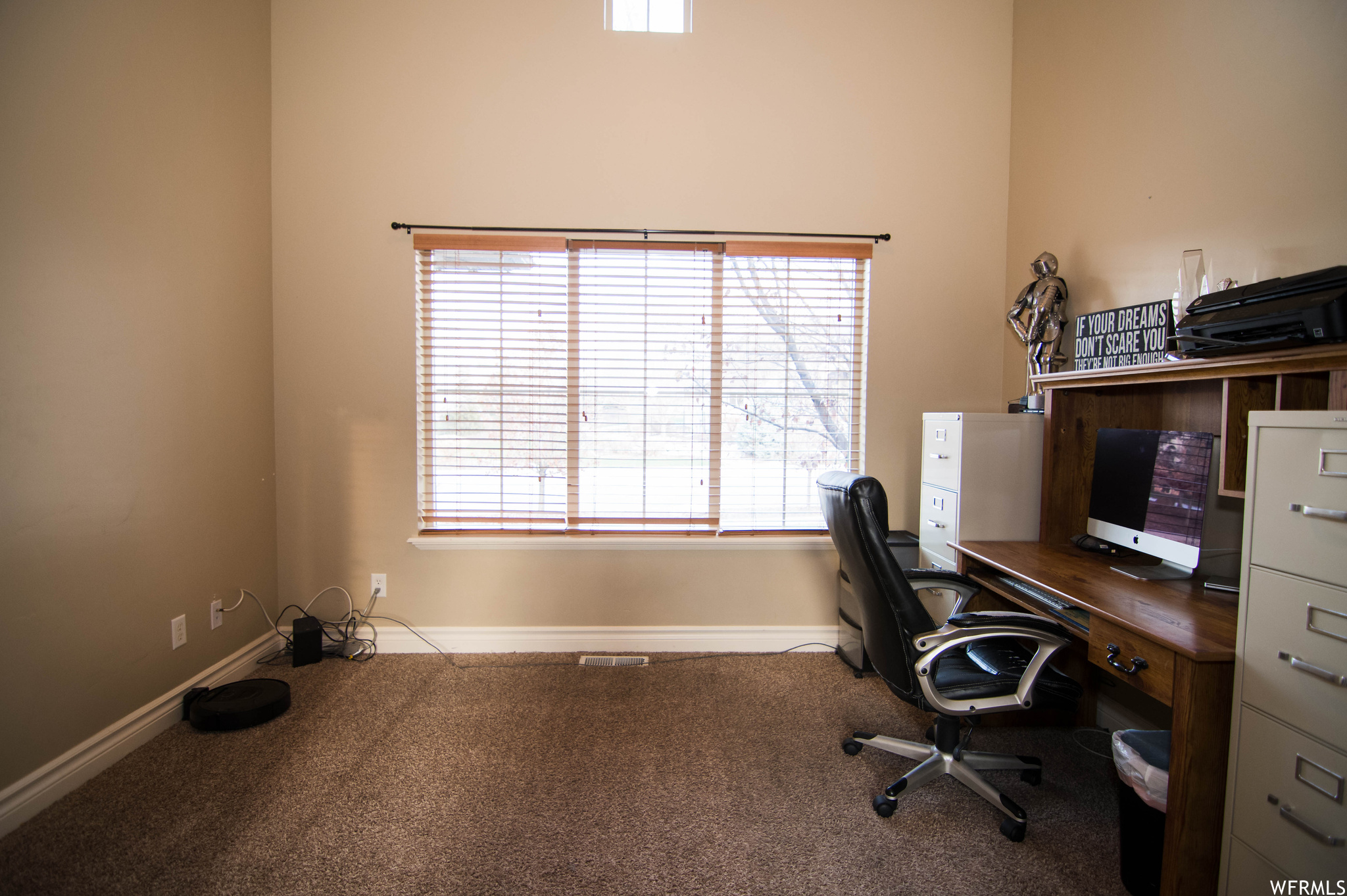 Carpeted home office with a healthy amount of sunlight