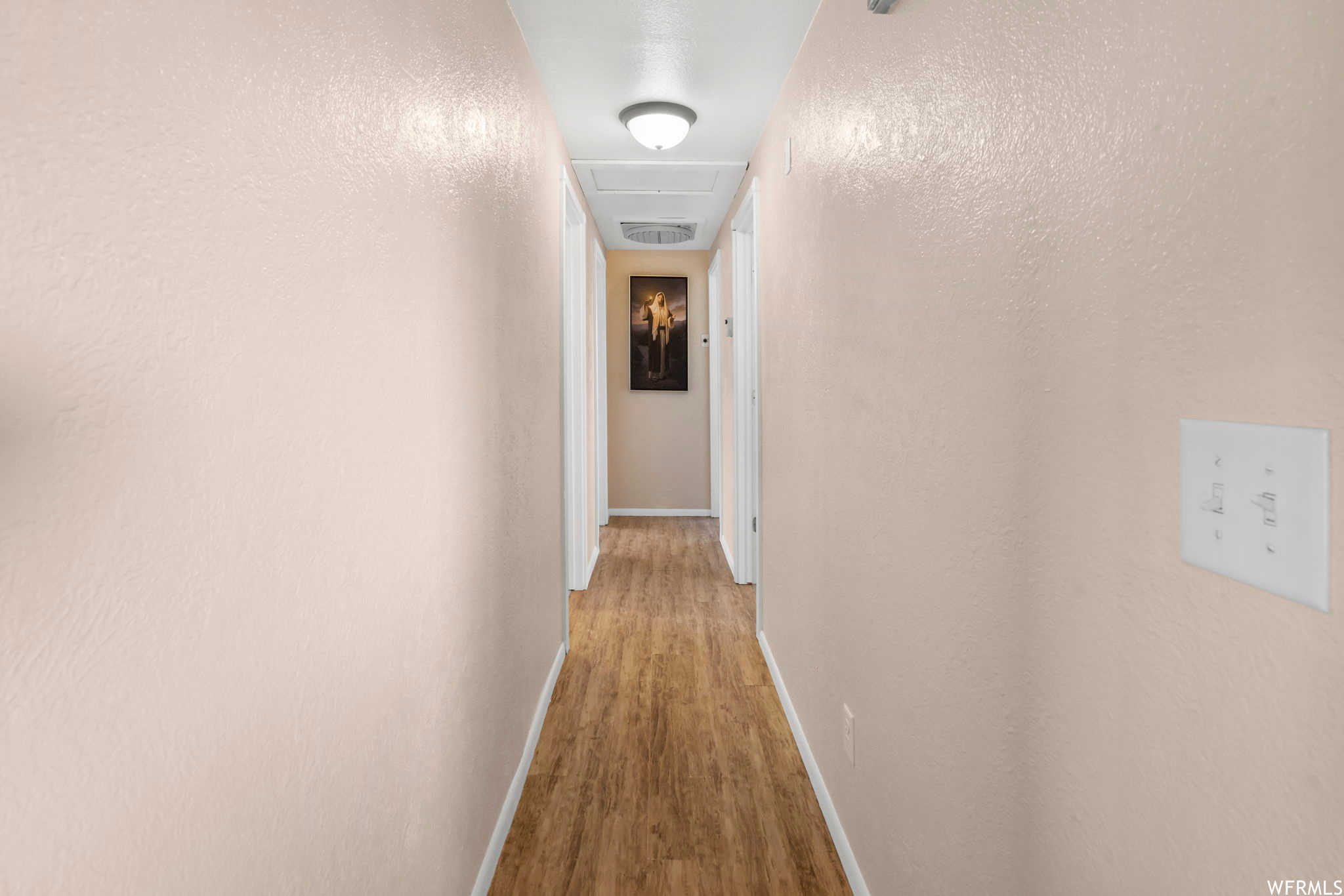 Corridor with light wood-type flooring