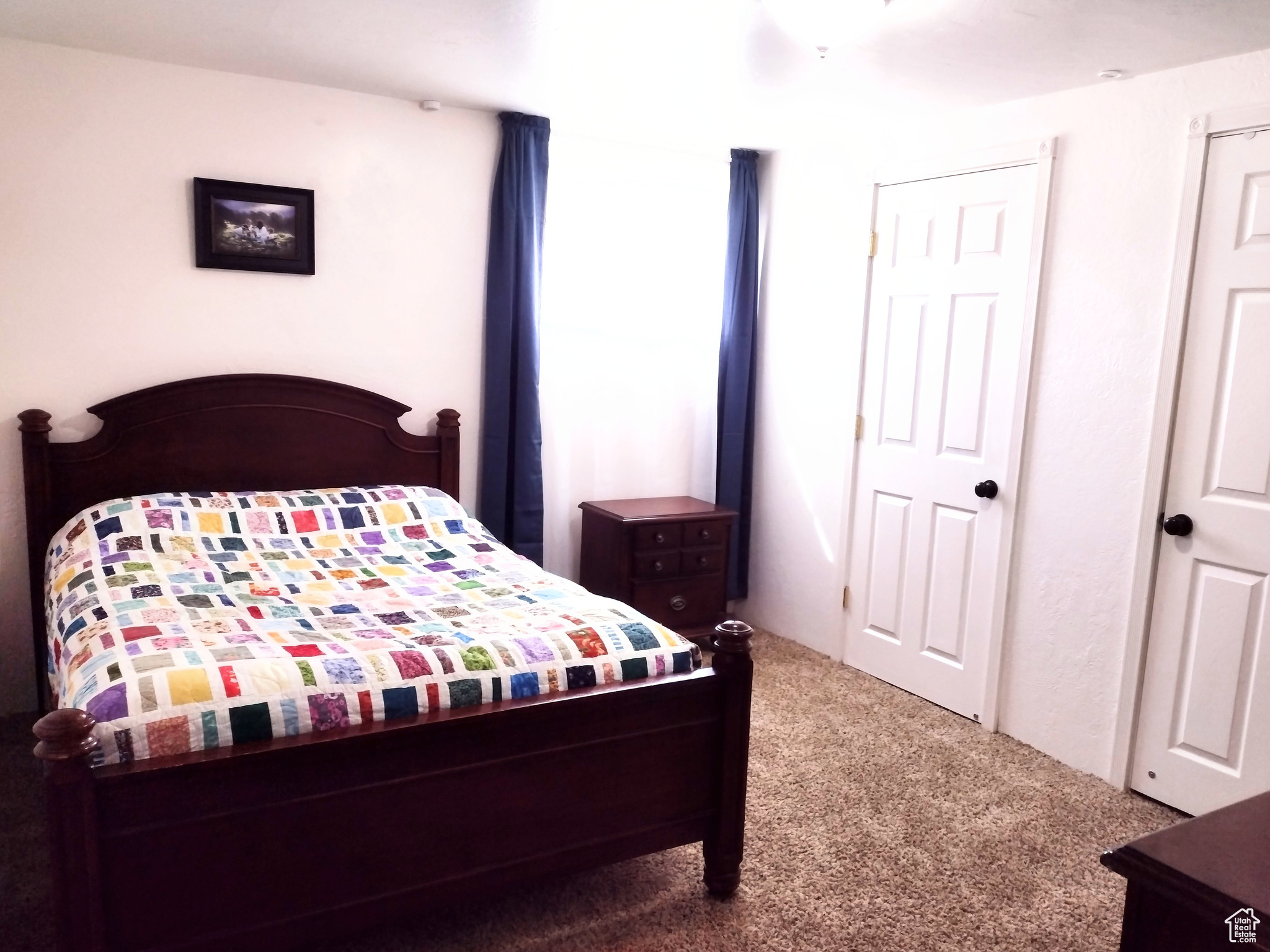 Bedroom with dark colored carpet