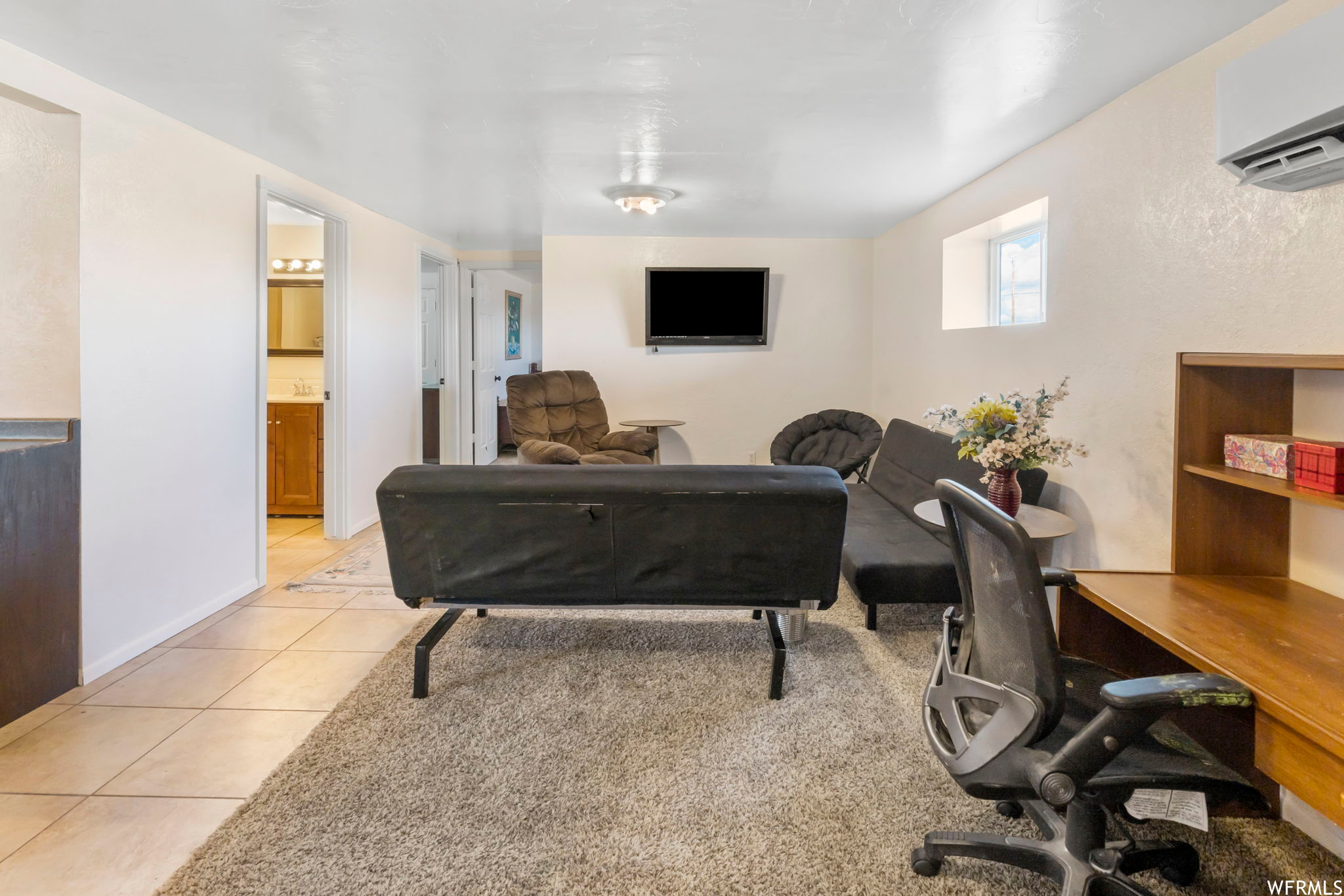 Living room featuring light tile floors