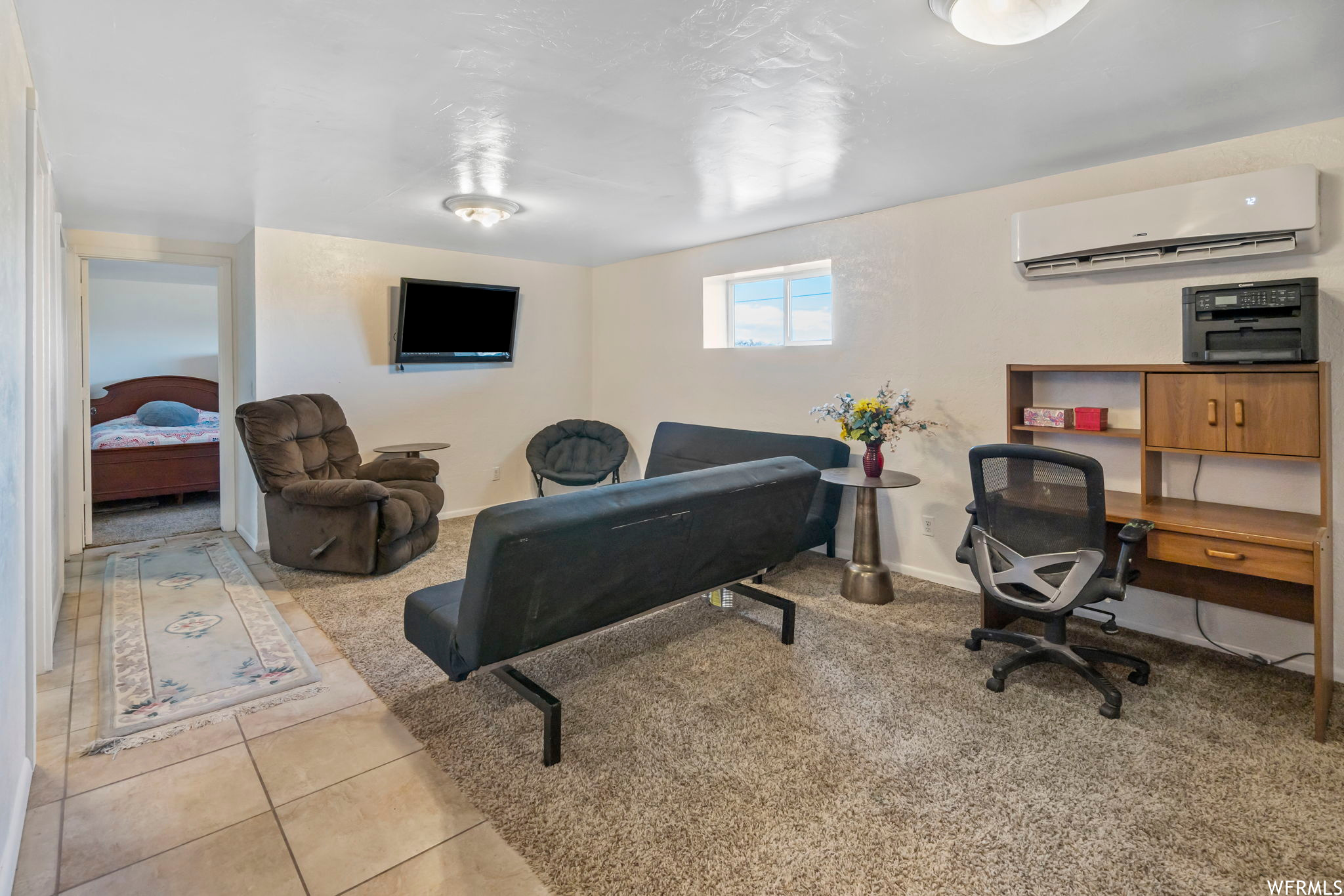 Office space featuring light tile floors and a wall unit AC