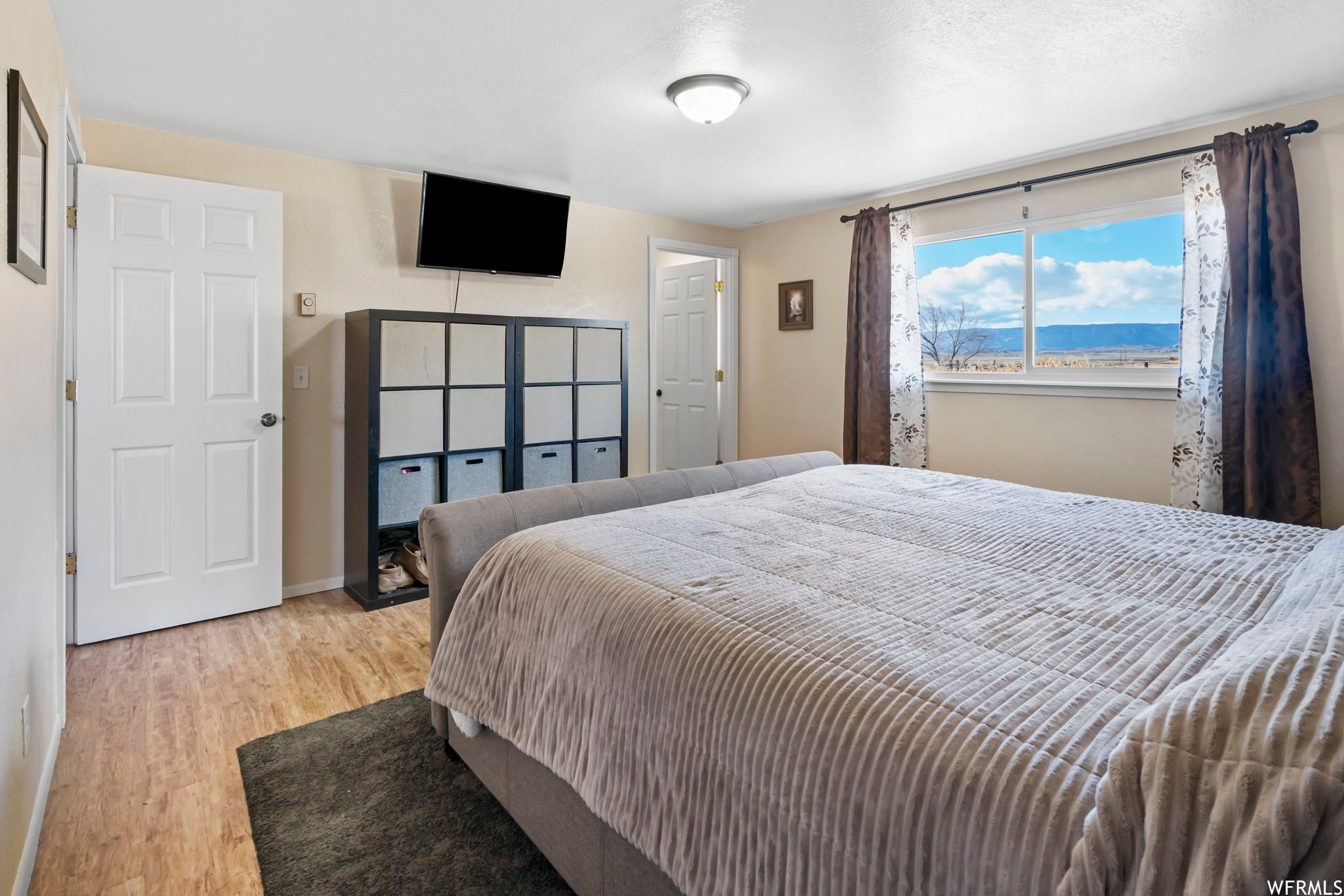 Bedroom featuring a water view and light hardwood / wood-style floors