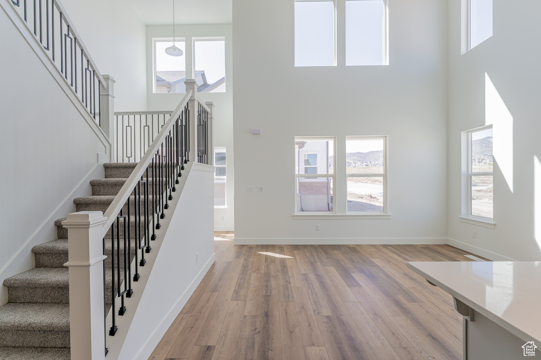 Foyer entrance featuring light hardwood / wood-style flooring and a high ceiling