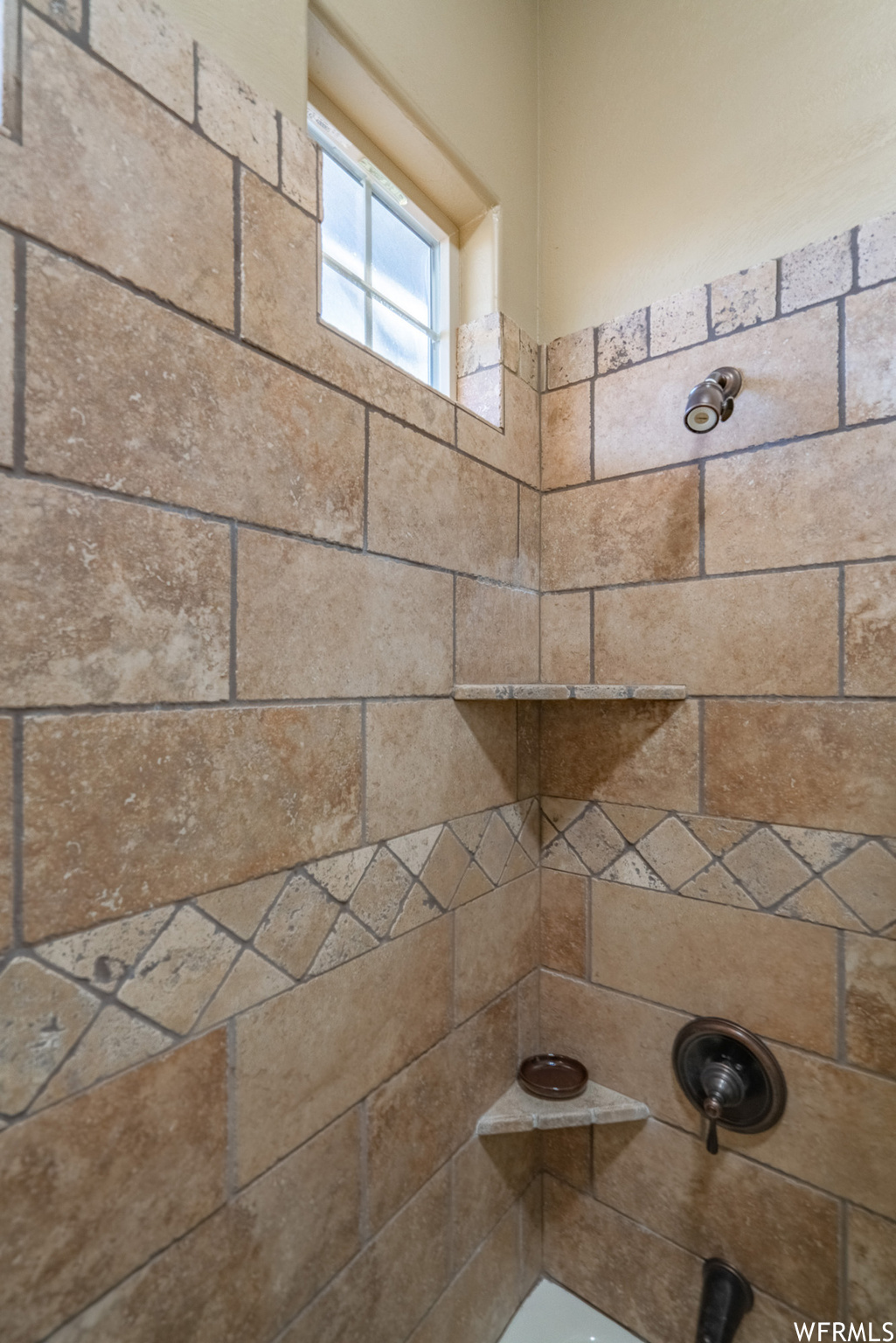 Interior details featuring tiled shower / bath combo