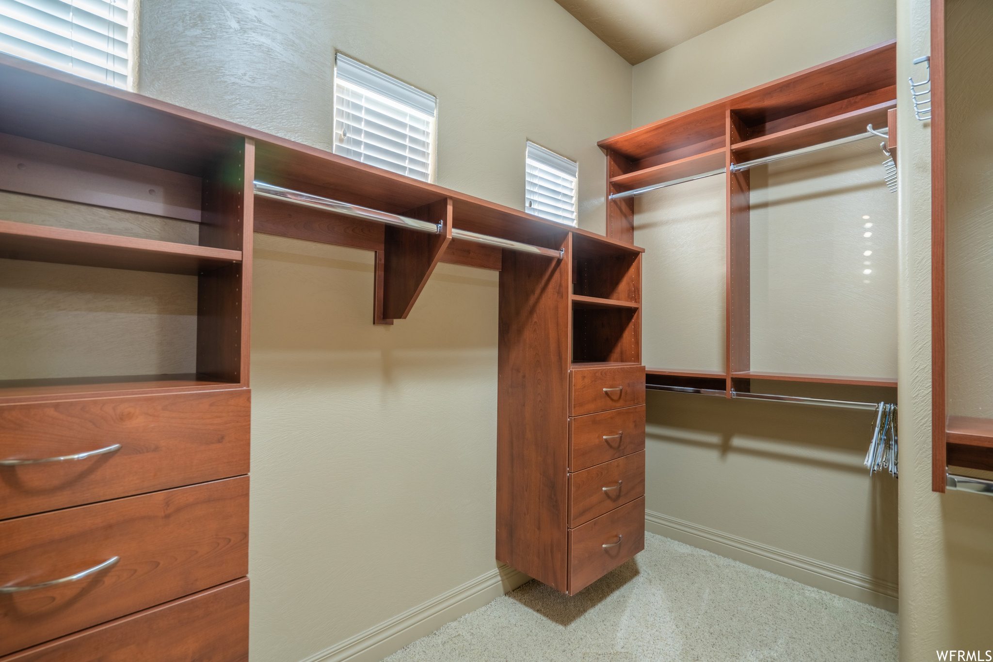 Custom Walk in closet featuring light carpet in Master Suite