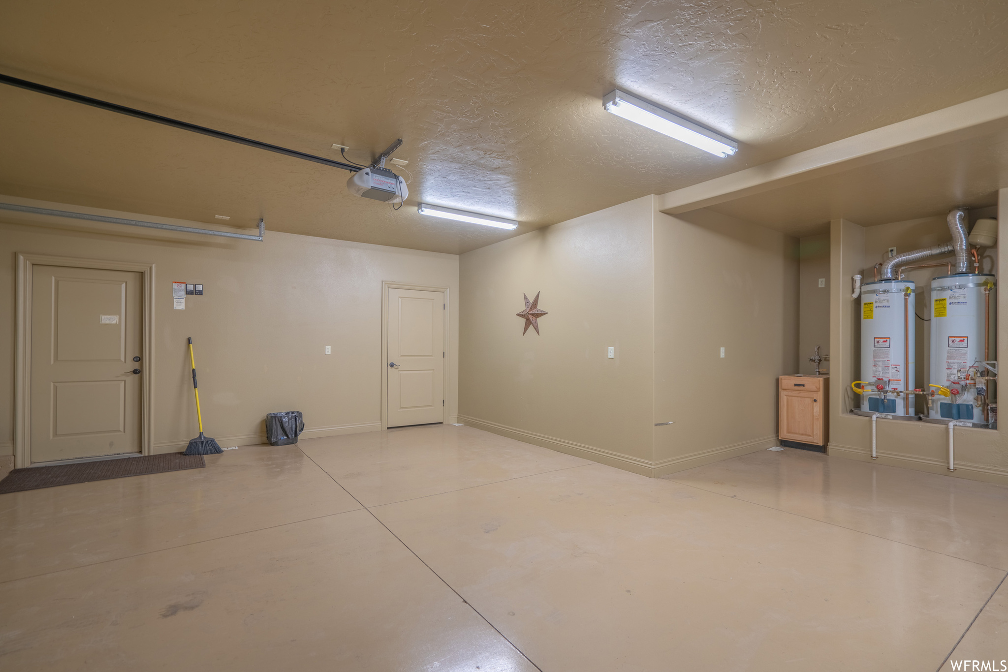 Garage with water heater and a garage door opener