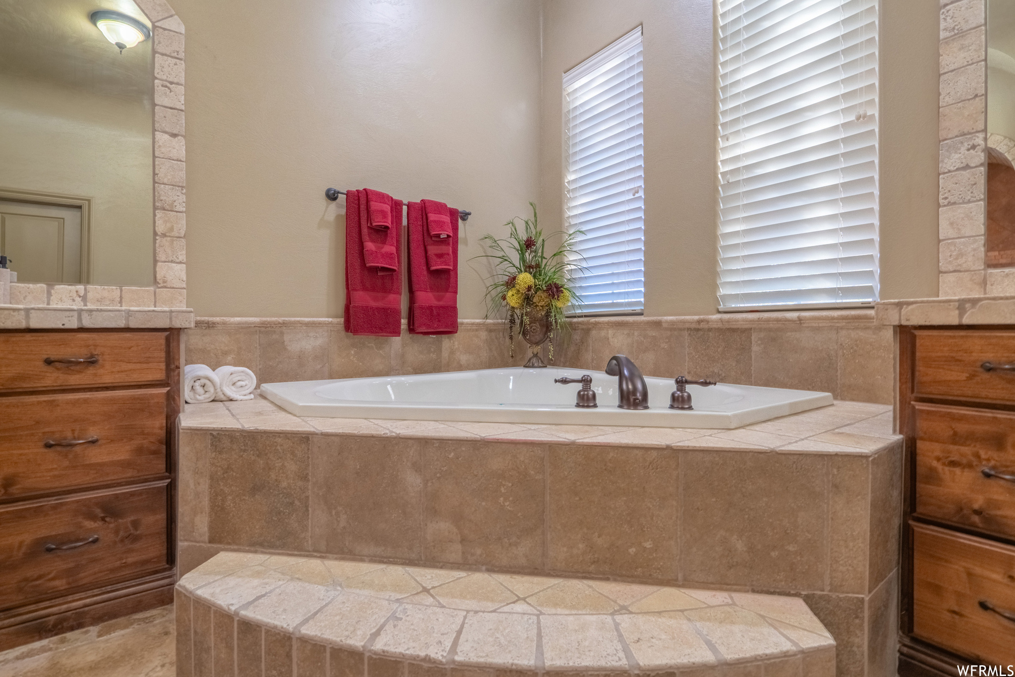 Bathroom featuring a relaxing jetted bathtub and vanity