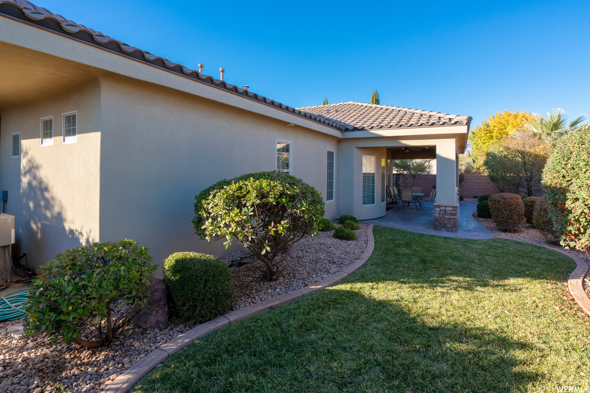 Exterior space featuring a patio area and a front lawn