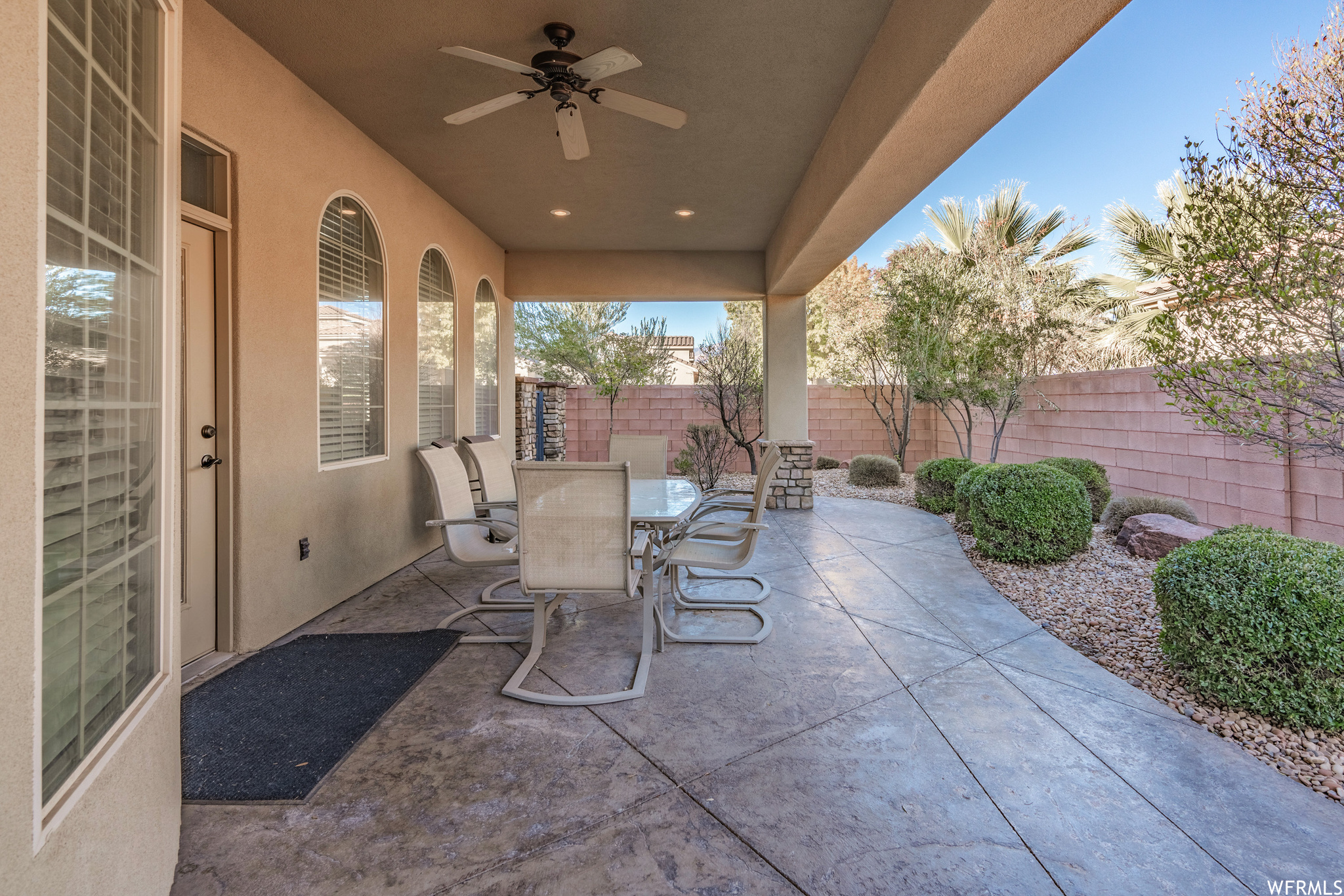 View of covered patio featuring ceiling fan