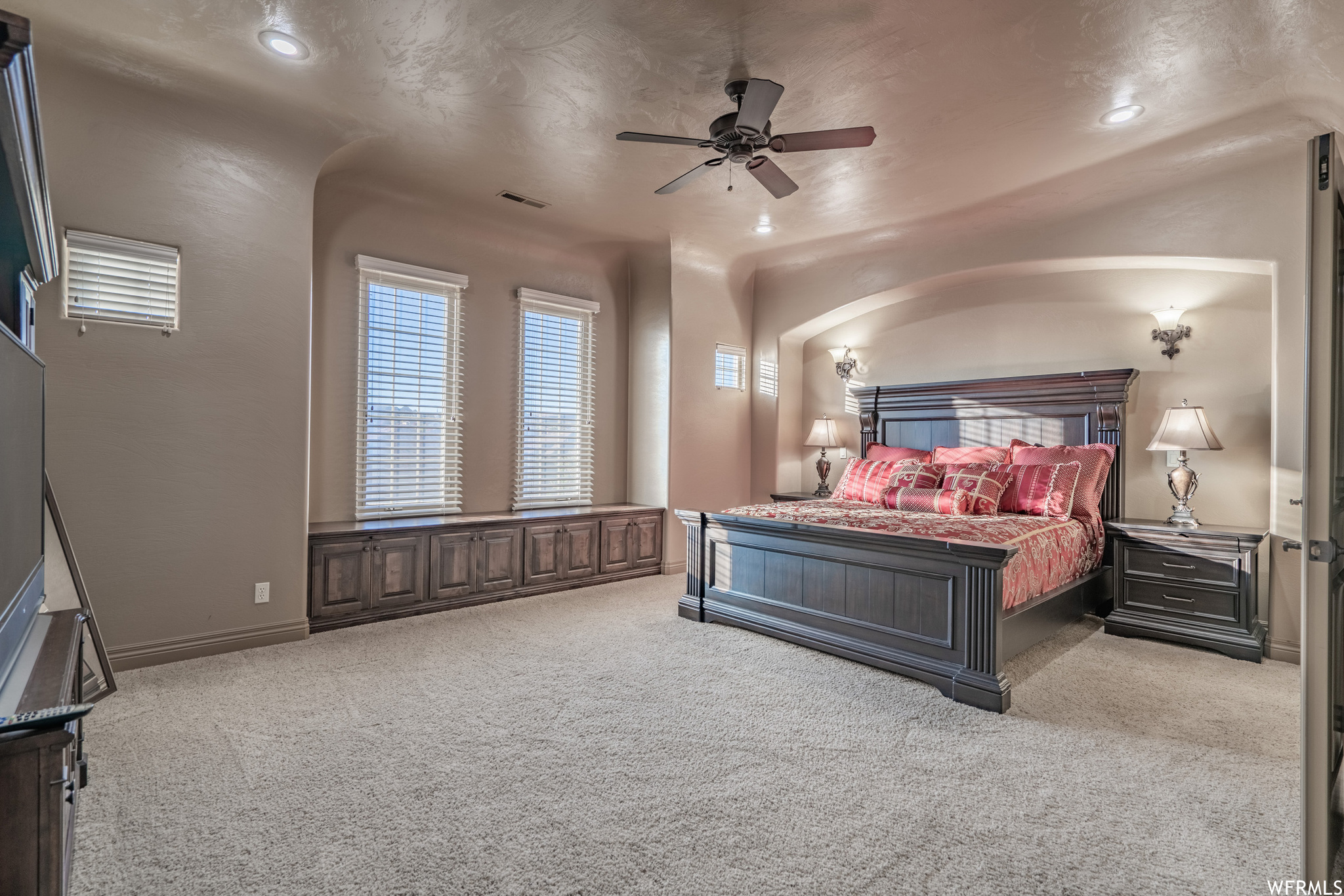 Carpeted bedroom featuring ceiling fan