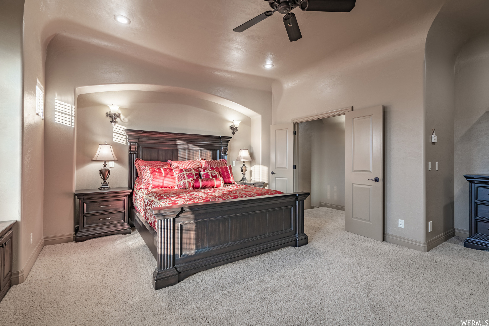 Carpeted bedroom with ceiling fan