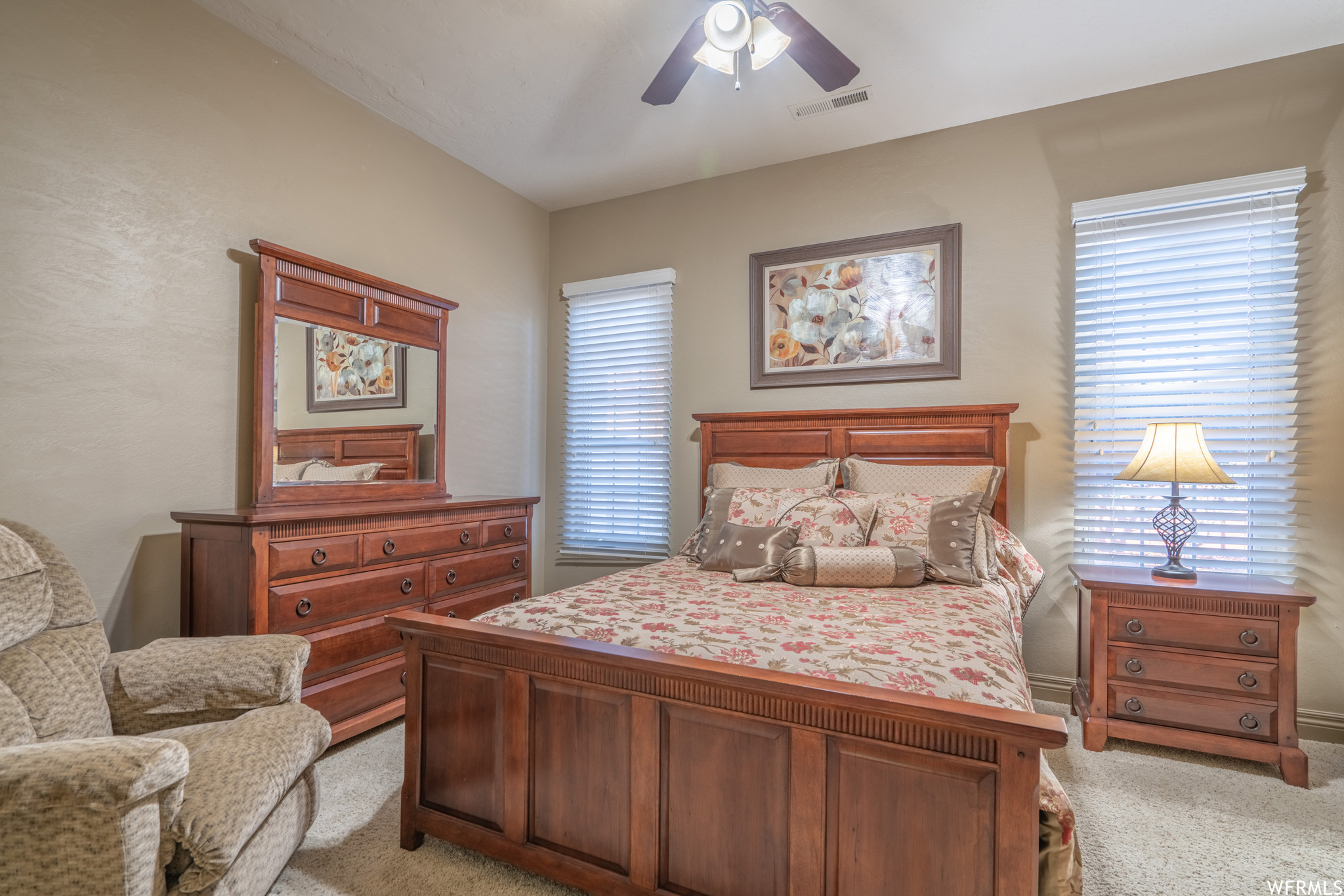 Carpeted bedroom with ceiling fan