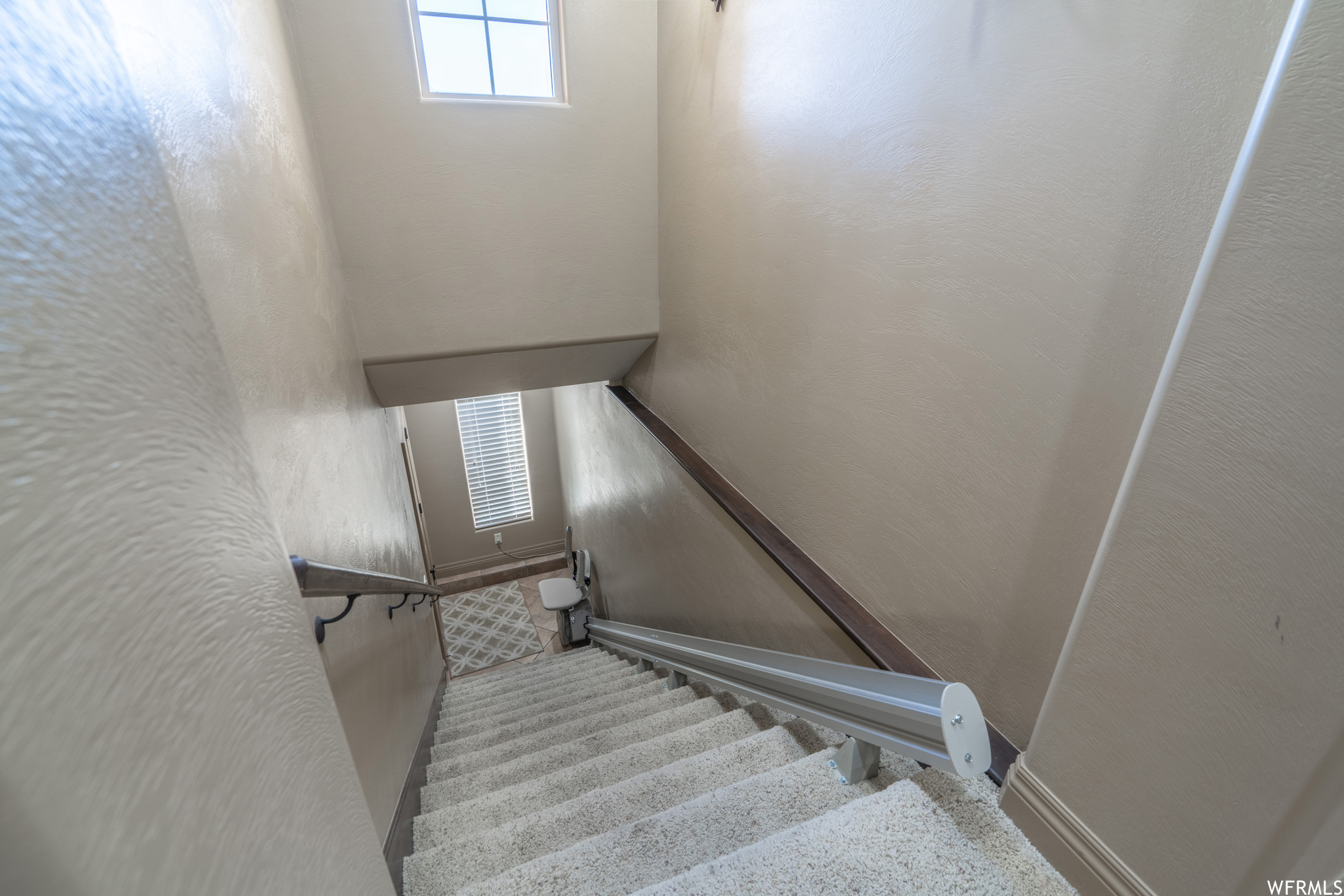 Stairs featuring carpet flooring and stair / chair lift