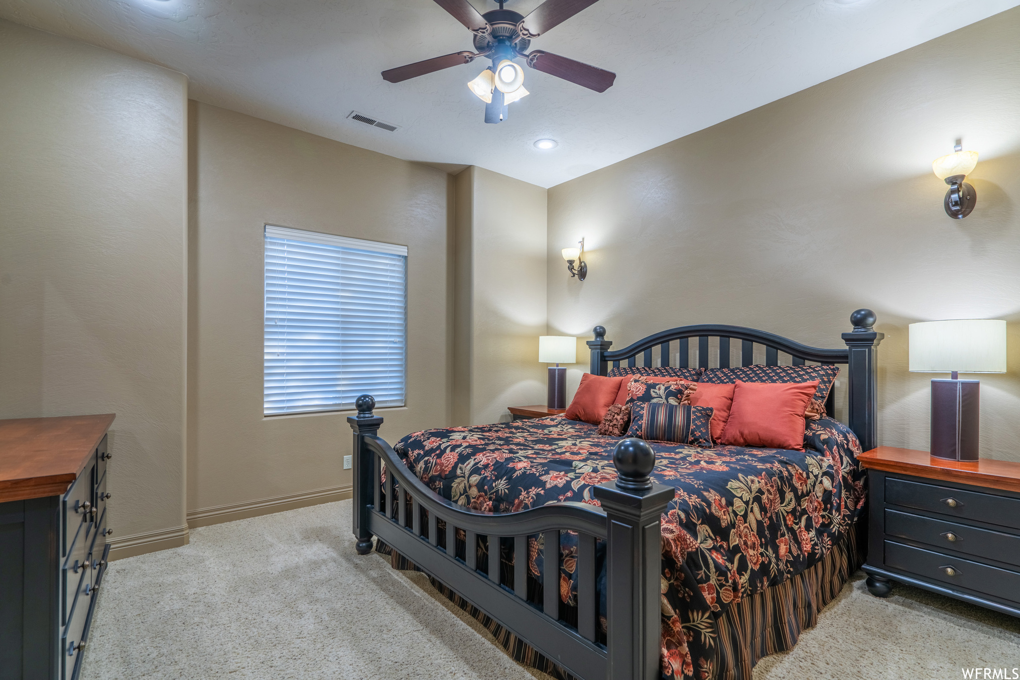 Carpeted bedroom featuring ceiling fan