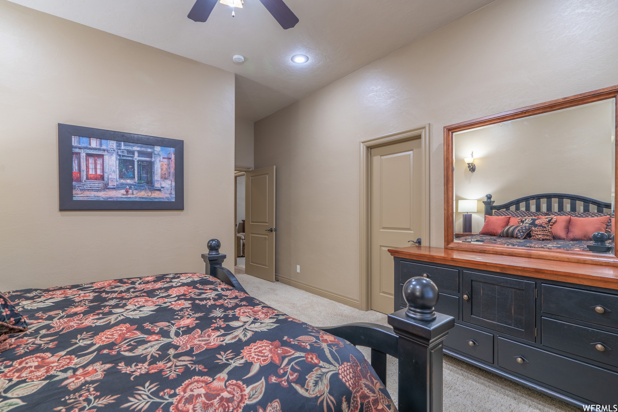 Carpeted bedroom featuring lofted ceiling and ceiling fan