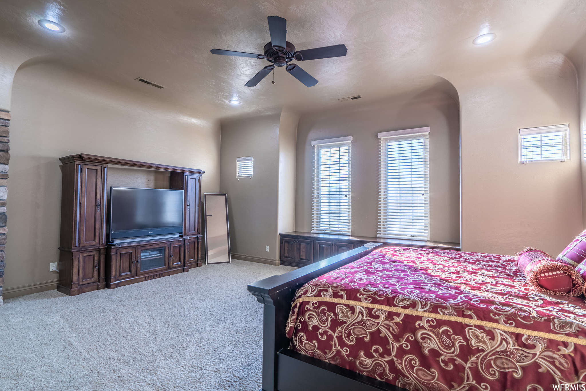 Master Bedroom featuring light colored carpet and ceiling fan