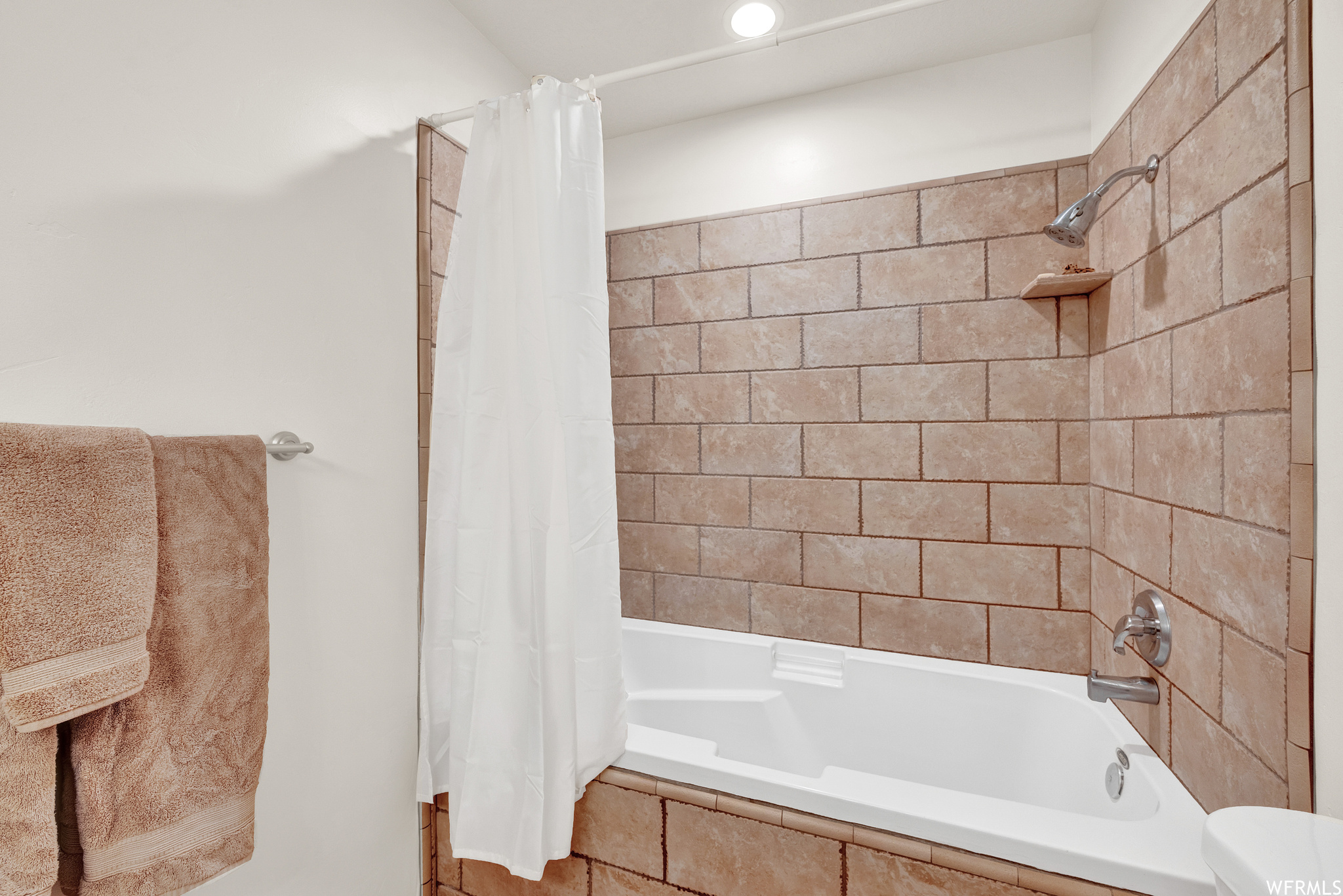 Level 2 Bathroom: Master ensuite bathroom with shower curtain, tub / shower combination, and toilet
