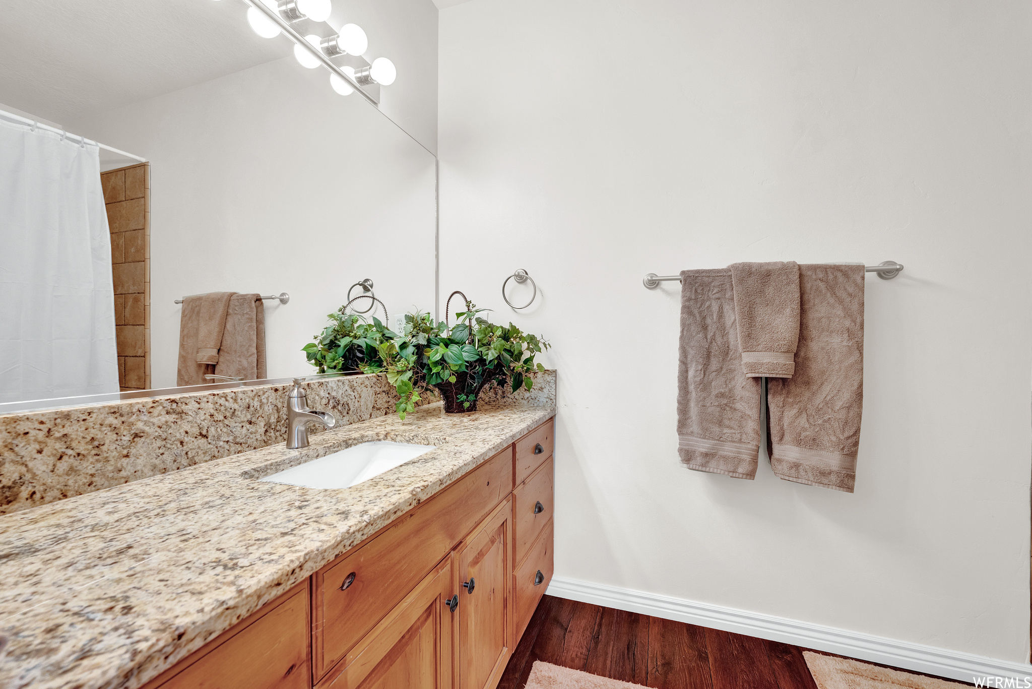 Level 2 Bathroom: Master ensuite bathroom featuring hardwood floors, vanity, mirror, and shower curtain