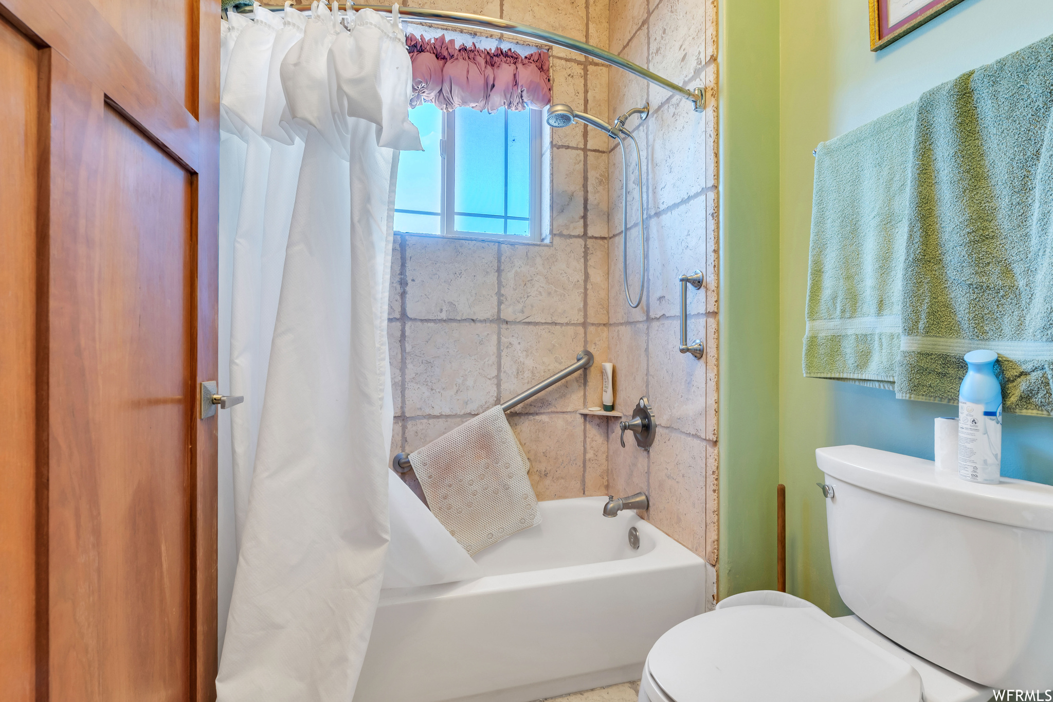 Bathroom with toilet and shower / tub combo