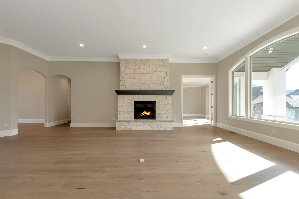 Unfurnished living room featuring light hardwood / wood-style flooring, a fireplace, and ornamental molding