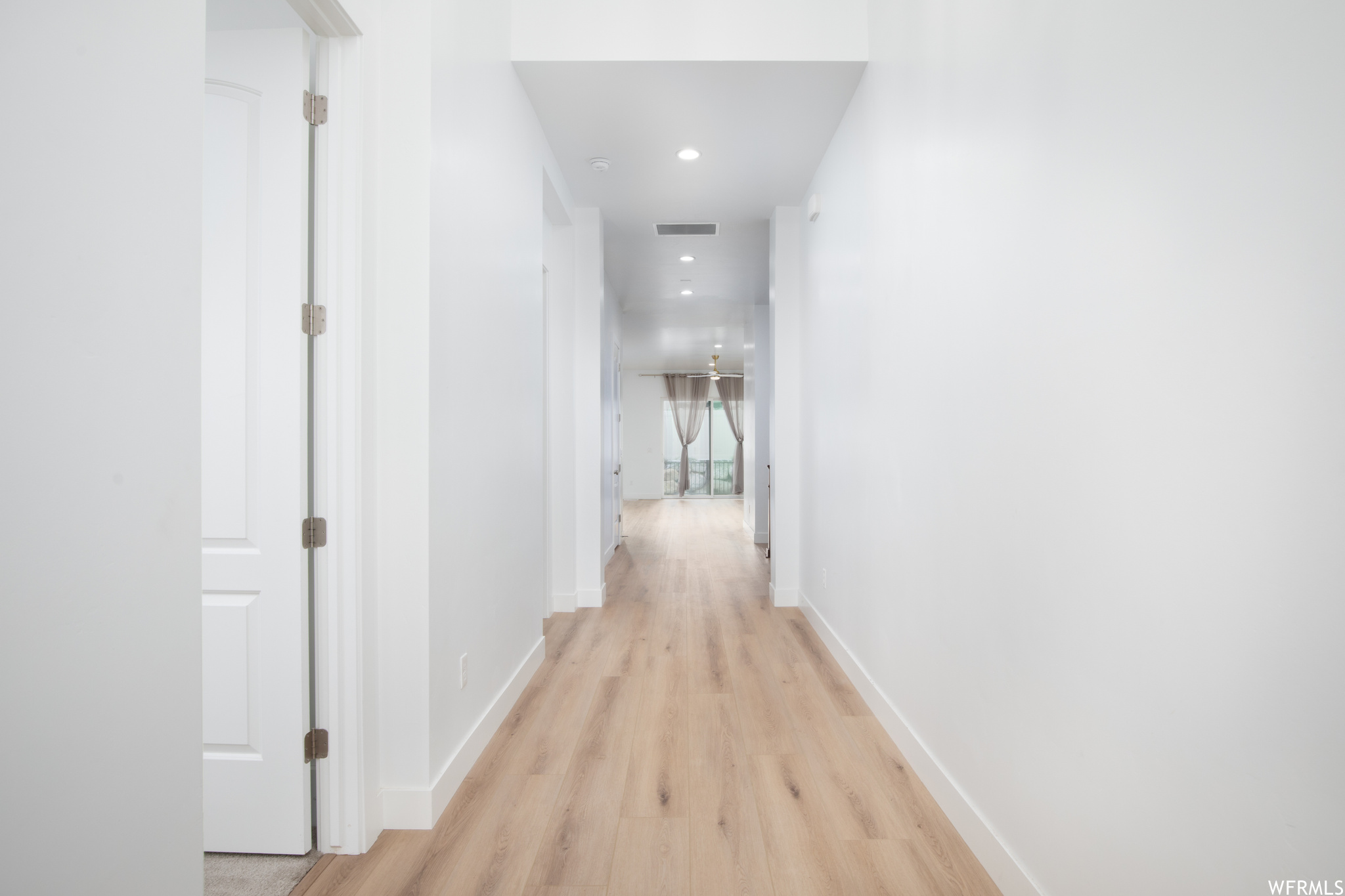 Hall featuring light hardwood / wood-style flooring