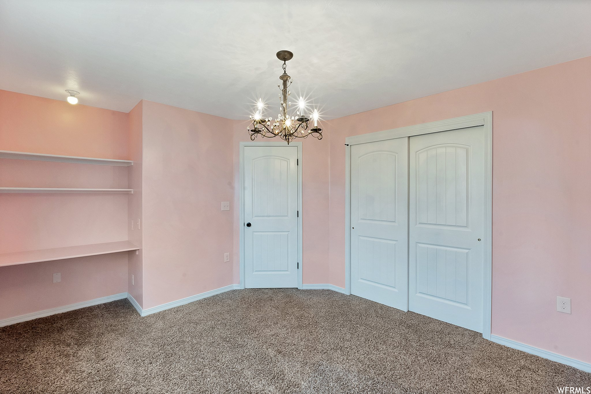 Bedroom with large closet and built in desk.