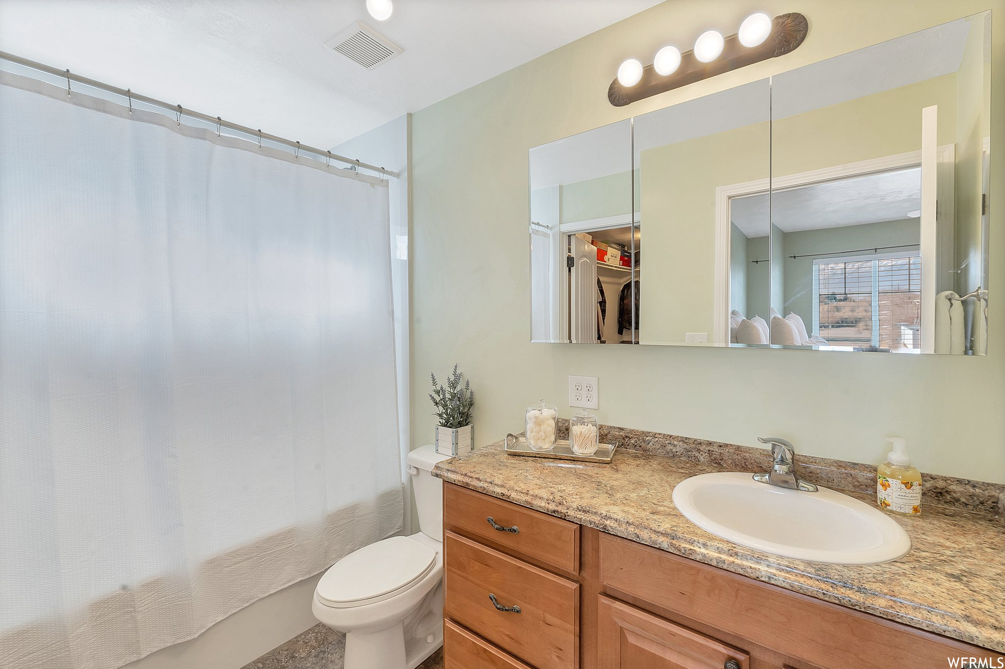 Master bathroom featuring large tub and oversized vanity, X large walk in closet.