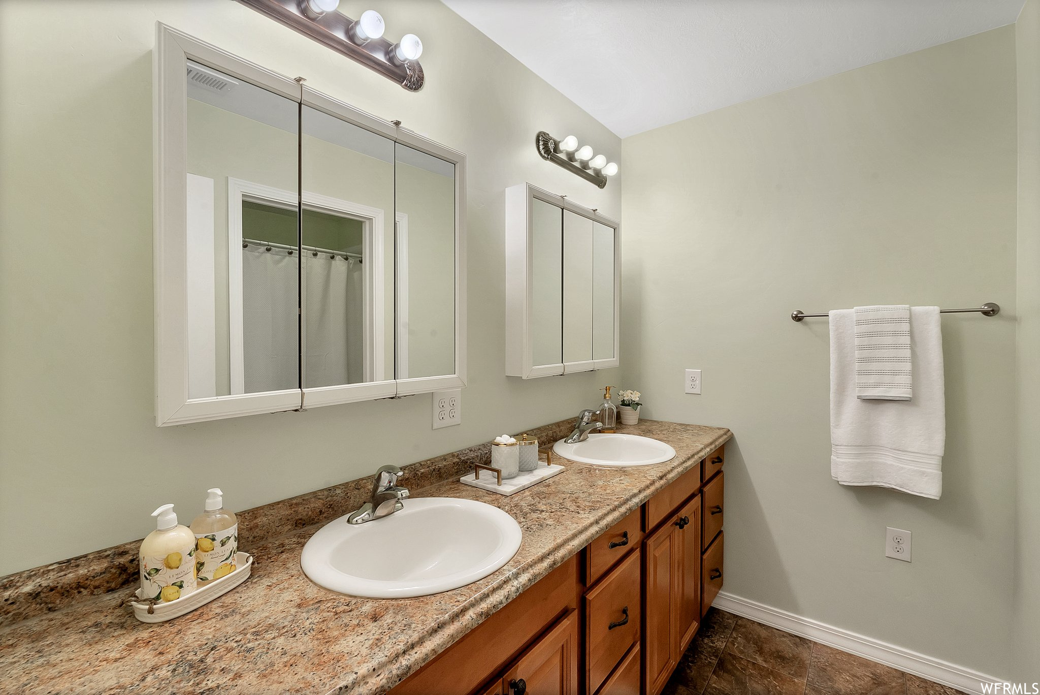 Bathroom featuring oversized vanity, double sink and storage space.