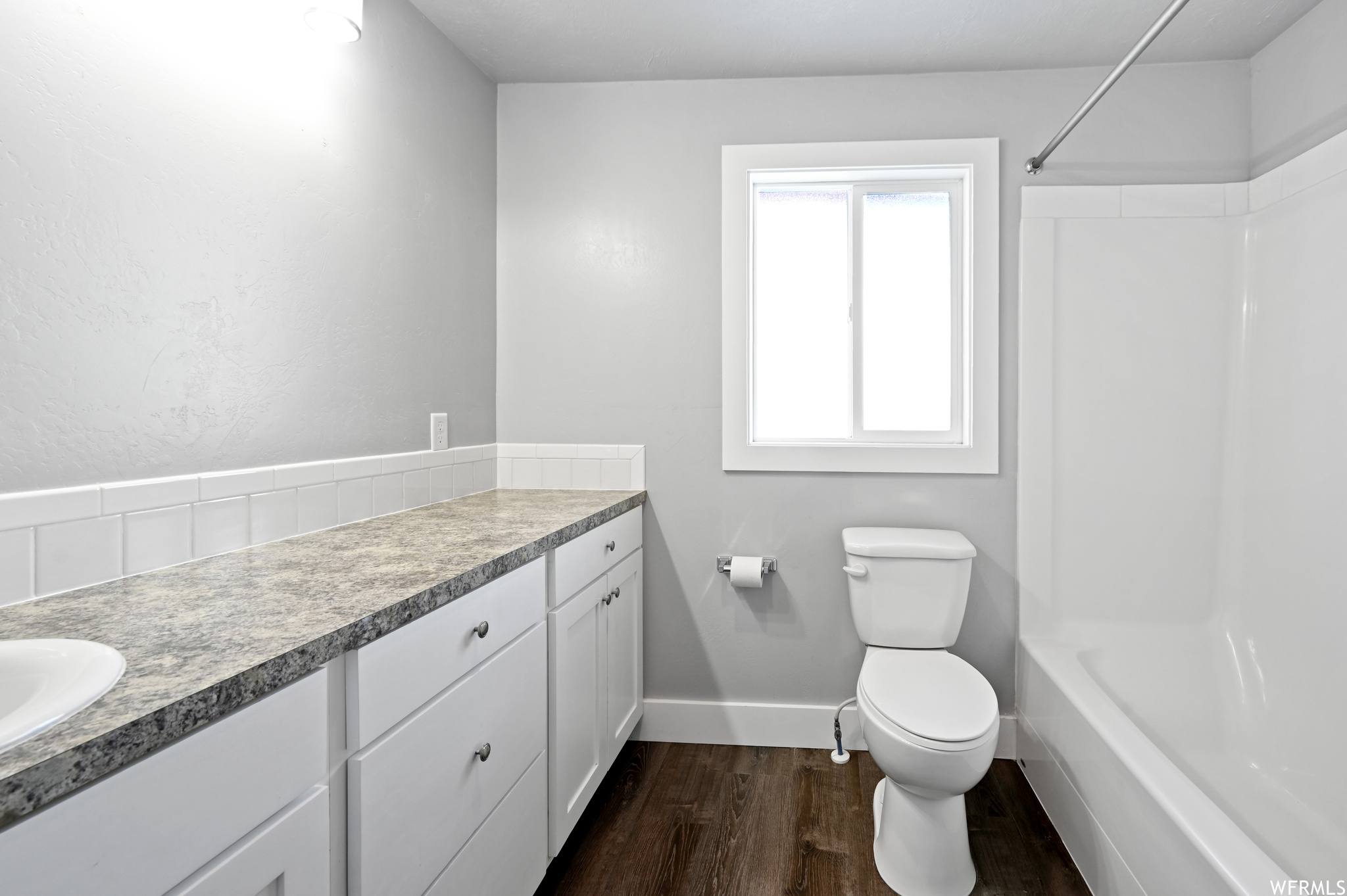 Master Full bathroom with bathtub / shower combination, wood-type flooring, vanity, and toilet