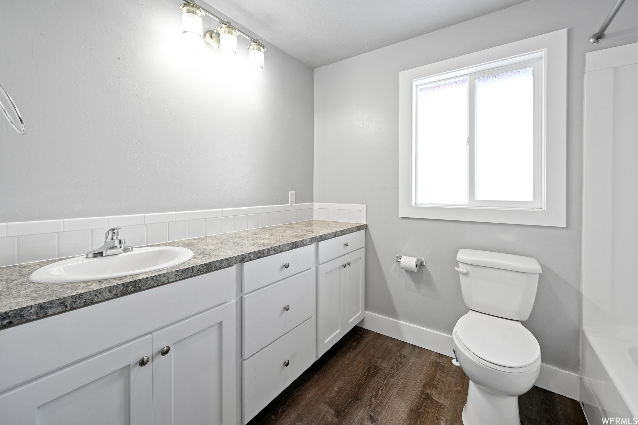 Master bedroom on suite Full bathroom with vanity, toilet, shower / bathtub combination, and hardwood / wood-style flooring