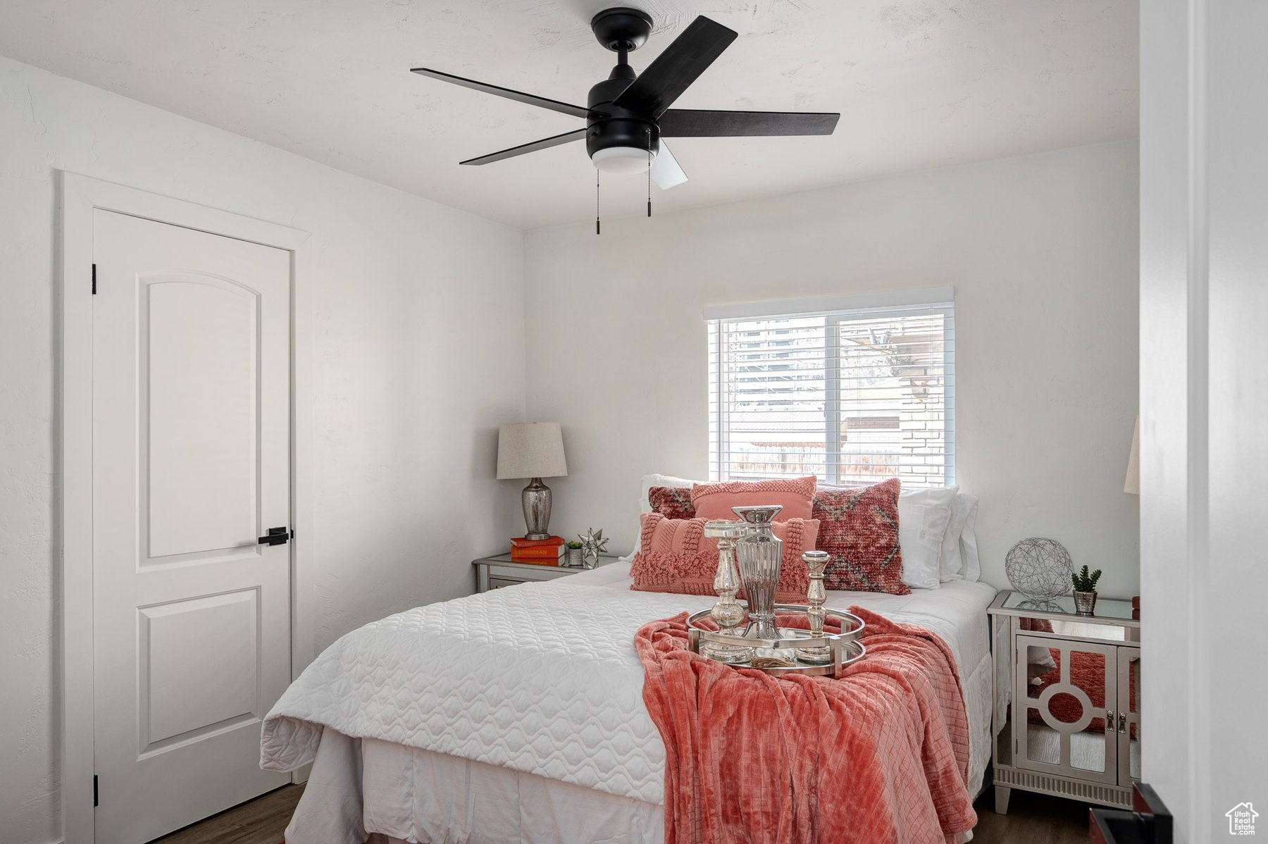 Bedroom with ceiling fan and natural light