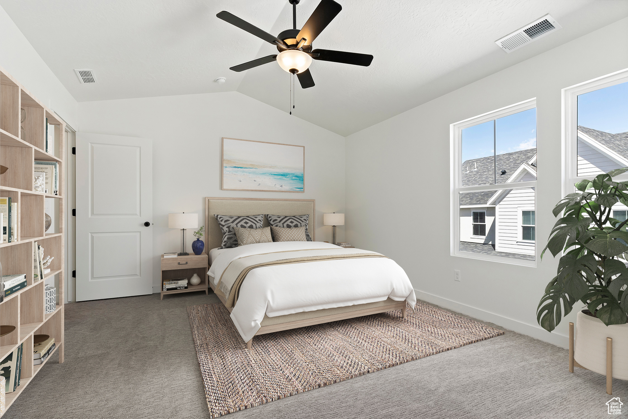 Bedroom featuring vaulted ceiling, dark colored carpet, and ceiling fan