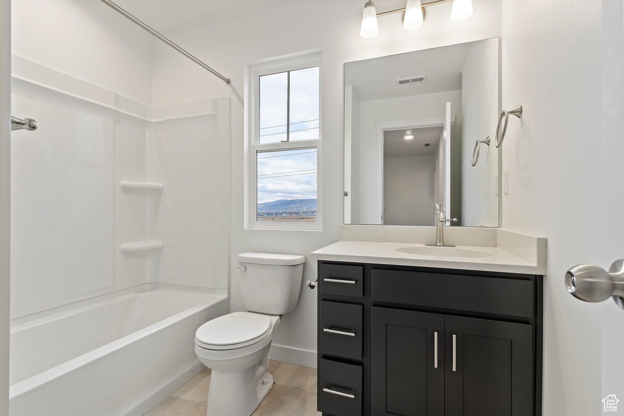 Full bathroom with vanity, tub / shower combination, and toilet