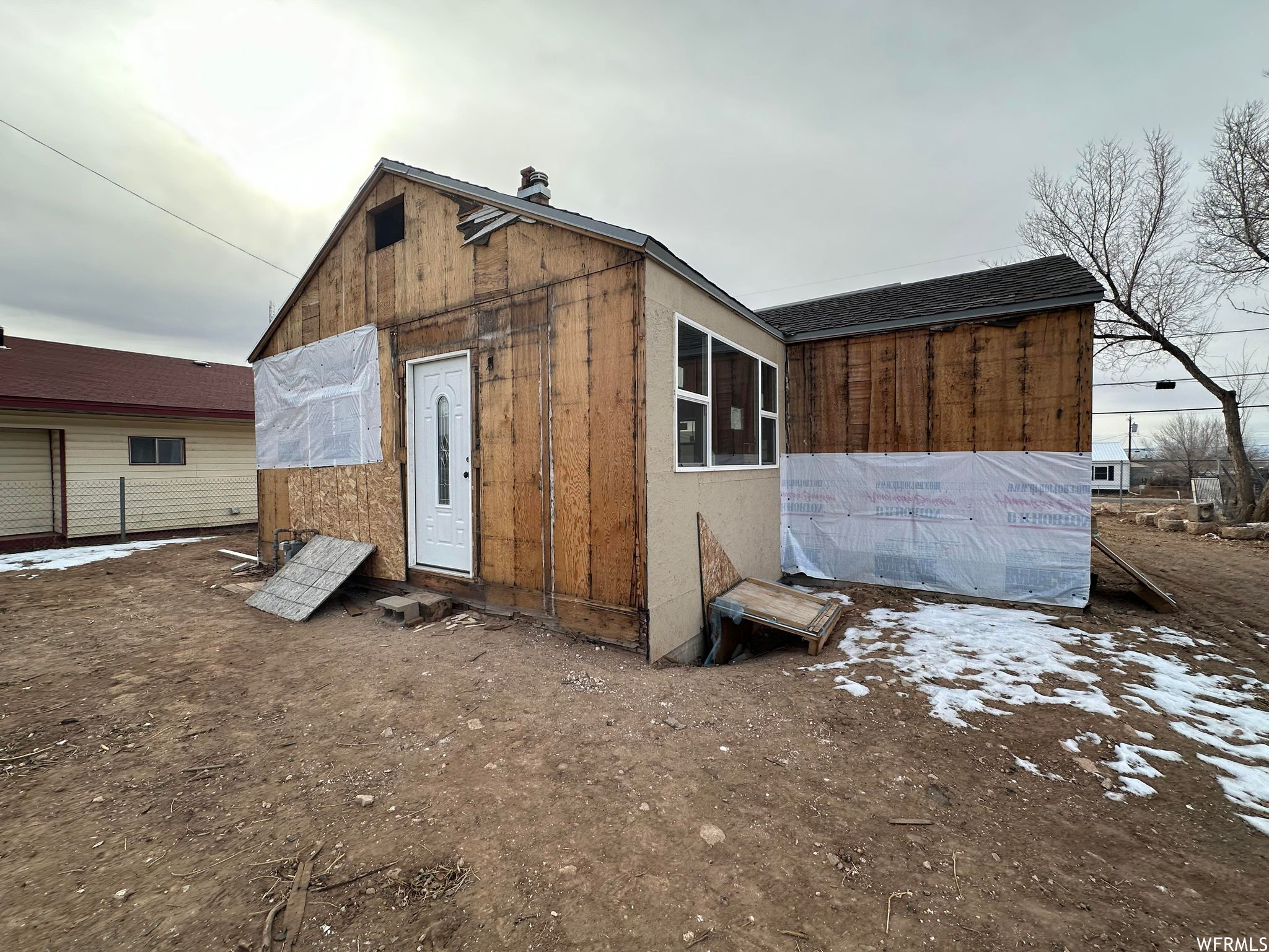 Back of property featuring an outdoor structure