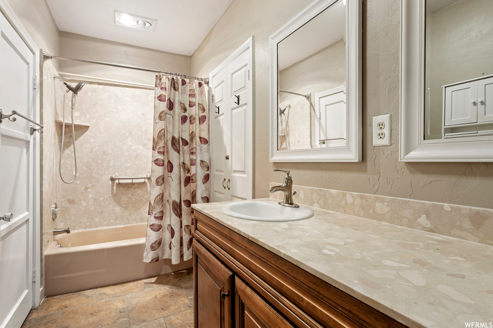 Bathroom featuring vanity, tile floors, and shower / bath combo