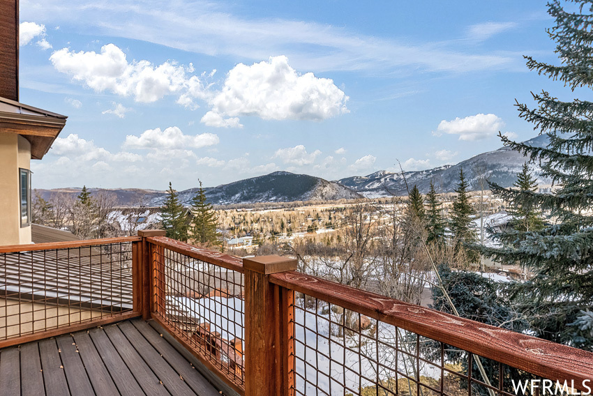 Snow covered deck featuring a mountain view